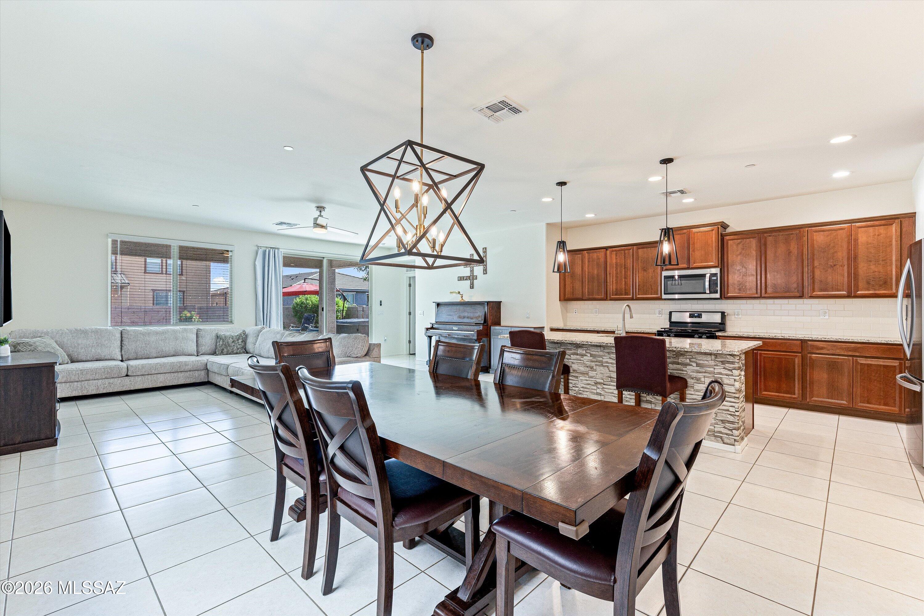 Nearly 3,000 square feet with 5 bedrooms, 3.5 bathrooms, a first-floor guest suite, spacious loft, and an oversized kitchen--all in the highly desirable Gladden Farms community. This move-in-ready home offers exceptional space, functionality, and value with an open-concept great room, abundant natural light, and a beautifully finished backyard perfect for relaxing or entertaining. As you step outside to a private backyard with an extended covered patio, pavers, & low-maintenance turf, creating the perfect space to relax.  This home is near two elementary schools, neighborhood parks, wide biking paths, splash pad, shopping, dining & more.