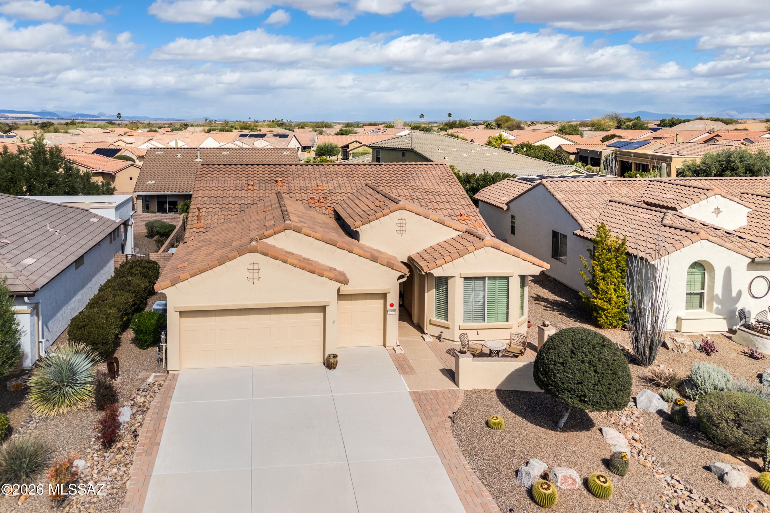 This beautifully maintained 2011 Agave model in Quail Creek offers 1,808 sq. ft., 2 BR, 2.5 BA, plus a versatile den, designed for both comfort and entertaining. A charming front paver courtyard welcomes you home and leads through the foyer into a spacious great room. Enjoy all-tile flooring, plantation shutters throughout, and upgraded fans and lighting that add style and comfort. The generous dining area comfortably seats six, perfect for hosting gatherings. The upgraded kitchen features granite countertops, abundant cabinetry with pull-out shelves in drawers and pantry, stainless steel appliances, a gas range, and an island with breakfast bar and pendant lighting. The extended owner's suite showcases a bay window, dual vanity bath with an all-tile shower, and a walk-in closet. A desirable split bedroom plan provides privacy, with the guest bedroom also extended with a bay window and its own en suite bath. A separate powder room offers added convenience for visitors. Step outside to a painted flagstone-look patio with extended pavers and a gas stub for a BBQ or future outdoor kitchen, surrounded by desert plantings and a privacy wall, ideal for relaxing or entertaining outdoors. Additional highlights include a laundry room with added storage and utility sink, and an extended garage with epoxy floors and a dedicated golf cart garage. Above the garage is approximately 21' x 7' of floored attic storage complete with lighting and pull-down stairs. HVAC system includes Reme Halo whole-house air purification system. Exterior re-painted in 2022. This exceptional home combines thoughtful upgrades, functional design, and resort-style living in a premier gated community.