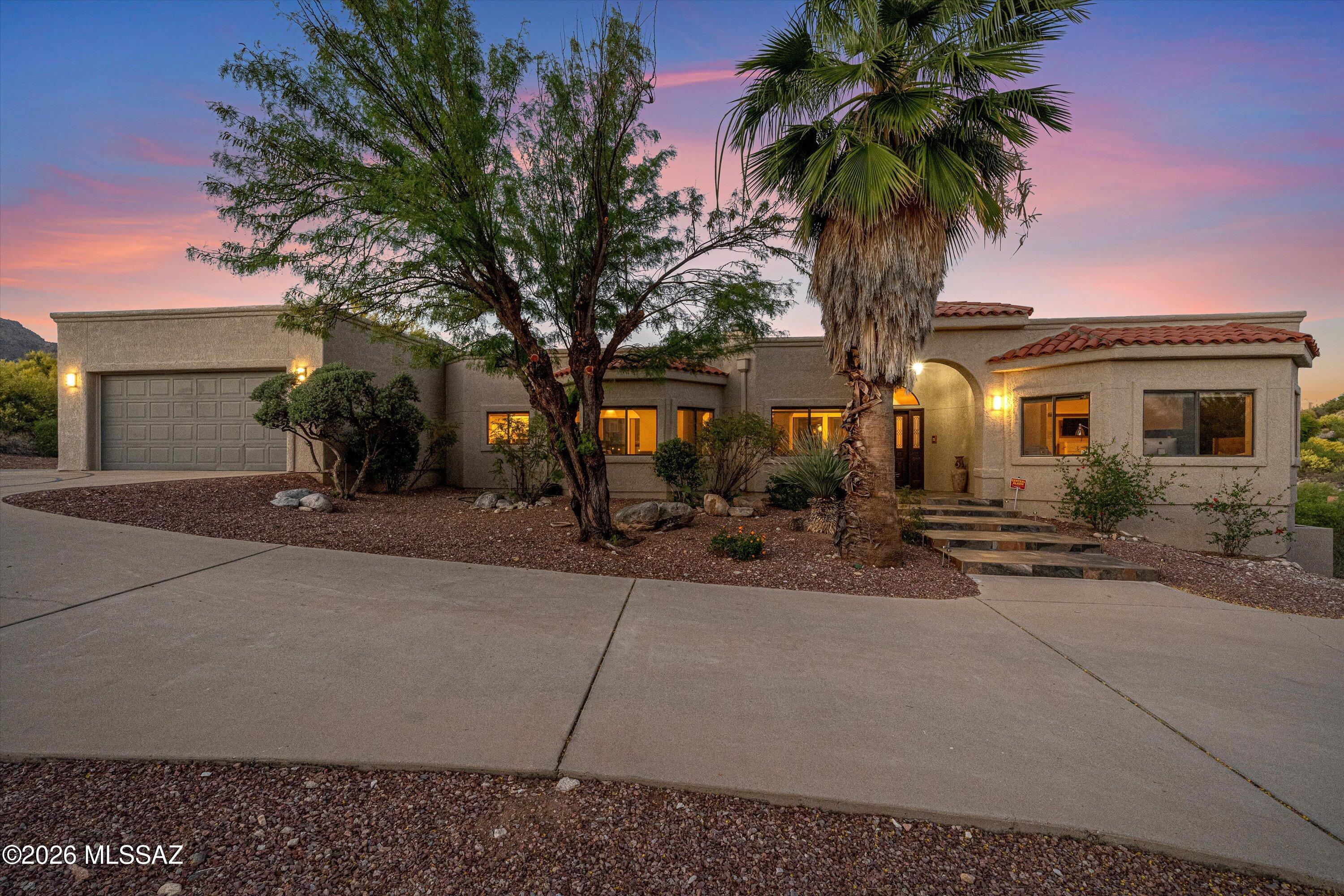 Enjoy a sparkling pool perfectly positioned to capture breathtaking views of the Catalina Mountains, creating a serene and picturesque backdrop for everyday living. This stunning contemporary home showcases both mountain and city views, highlighted by an exquisite living and family room connected by a dramatic two-way fireplace and soaring ceilings.
The thoughtfully designed layout features a formal dining room, a light-filled open kitchen, and a charming breakfast area. Beautiful tile floors flow throughout, enhancing the spacious design, which includes 4 well-appointed bedrooms and 3 baths. The primary suite serves as a private retreat with its own cozy fireplace and walk-in closets.
Adding to the home's appeal, it is equipped with owned solar and 2 Tesla Powerwalls. Ideally located near premier golf, scenic hiking and biking trails, and the natural beauty of Sabino Canyon, this home offers the perfect balance of adventure and tranquility.

Cimarron Foothills Estates has 24-hour roving security.