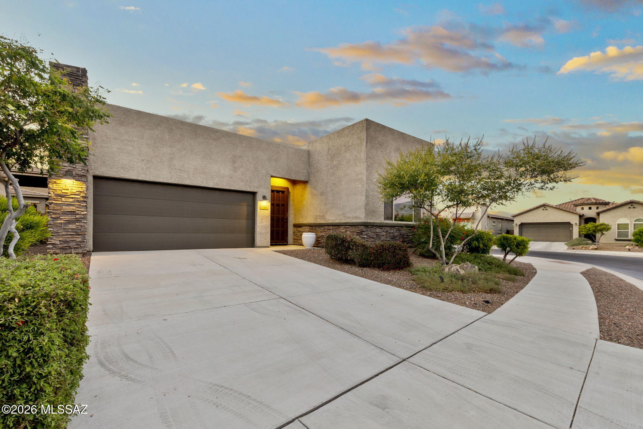 Built in 2019, this contemporary residence in Viewpointe at Vistoso Trails showcases breathtaking Catalina Mountain views from a premium corner lot. The thoughtfully designed 1,796 sq ft floor plan features 2 bedrooms, 2 baths, and a versatile den. At the heart of the home, the open-concept great room flows seamlessly into a chef's kitchen with an oversized granite island, stainless steel appliances, rich espresso cabinetry, and generous prep space. High ceilings, ceramic tile flooring, abundant natural light, and a spacious primary suite create an inviting, sophisticated retreat. A covered patio, low-maintenance landscaping, and a 2-car garage complete the home. Conveniently located just minutes from world-class golf, scenic hiking trails, premier shopping, and dining.