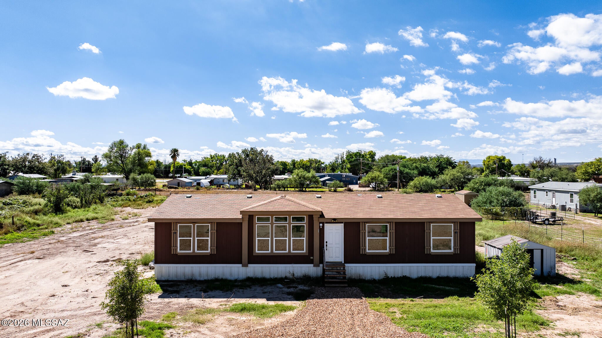 Enjoy country living on 1.25 acres in beautiful St. David! This spacious 4-bedroom, 2-bath manufactured home features a bright, open floor plan with plenty of natural light and laminate flooring throughout. The primary suite offers a walk-in shower, while the inviting living spaces provide room to relax, gather, and make yourself at home. Outside, a rocked circular driveway welcomes you in, with plenty of space for parking, outdoor activities, and enjoying the wide-open Arizona skies. With room to spread out and make it your own, this property offers the space and flexibility you've been looking for. Come see the possibilities!
