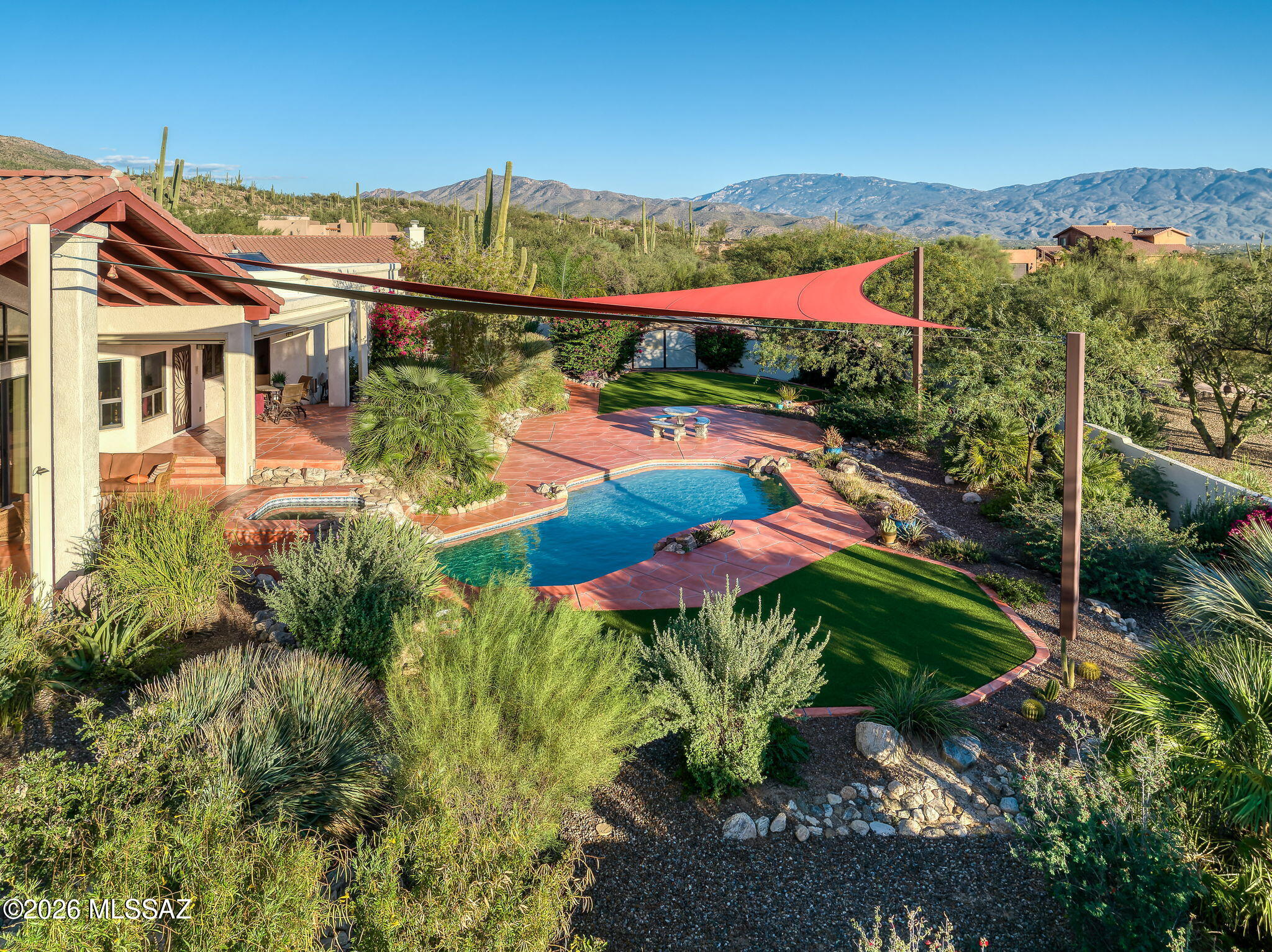 Range Price $1,995,000-$2,200,000 The ultimate enthusiast's paradise, designed as a true compound for collectors, adventurers, and automotive enthusiasts. This estate delivers refined residential living with serious infrastructure from an elevated 2.8-acre homesite with uncommon privacy & commanding 360-degree views. Located in the lush Tanque Verde Valley, high in the foothills of the Catalina Mountains, this 4,090-main residence with 5 bedrooms/5 bathrooms, and an oversized three-car garage is complemented by an 826-square-foot private guest house with a dedicated garage. In addition, there is a 1,200-square-foot temperature-controlled automotive workshop and a massive 1,608-square-foot RV garage--capable of accommodating virtually any RV, trailer, or boat. New solar panels ...CONTINUED located on the ground away from the house provide efficiency without compromising the roof. Surround yourself with the magical beauty of the saguaro-studded hills as you take in Tucson's iconic sunsets, then watch the city lights emerge as starry skies reveal themselves in the darkness of night. Water-conscious landscaping that does not sacrifice beauty or color delivers dynamic,  resort-quality grounds.

The Residence:
The circular driveway on the north side of the property leads to the covered entry with stacked-stone columns and a custom-designed wrought-iron screened door. An impressive entry with high ceilings introduces interiors that reflect timeless desert craftsmanship and thoughtful design. Porcelain plank flooring flows throughout the home, complemented by solid alder interior doors and hickory cabinetry. The formal living and dining rooms lead to the open kitchen and great room with beamed ceilings and a two-sided, zero-emissions gas fireplace.
An additional flex space with a fully equipped wet bar which includes a beverage refrigerator, and a wine refrigerator currently accommodates a pool table but could be used for anything needed. Live the ultimate Arizona lifestyle with seamless indoor/outdoor living and entertaining. The space flows effortlessly to the serene backyard with awe-inspiring valley and sunset views and a deep covered patio that extends the full length of the back of the home. Low-care artificial turf brings color and provides space for dogs and kids to play, while low-water yet colorful and lush plants, shrubs, and trees create a resort feel without high water bills.
The split-bedroom floor plan features generously sized rooms and bathrooms. The third bedroom in the main house is currently a combination of two bedrooms and can be separated again if needed. The gourmet kitchen features hickory cabinetry anchored by a center island with breakfast bar and prep sink. A large skylight floods the kitchen with natural light, while gorgeous city and sunset views are enjoyed from the kitchen sink and breakfast nook.
The oversized primary suite offers direct patio access, a huge walk-in closet with custom built-ins, and a luxury bathroom with dual-sink vanity, jetted tub, and separate shower. A separate office features custom built-in cabinetry, granite countertops, three workstations, two desks, and substantial storagecreating the ideal work-from-home environment. The fully outfitted laundry room includes a sink and extra storage cabinetry.
Recent upgrades elevate efficiency and longevity, including a tile roof and underlayment replacement in 2023, lifetime RhinoShield ceramic exterior coating for enhanced heat rejection, and newly installed solar panels delivering impressively low energy costs. Two high-efficiency 19-SEER HVAC systems (2022) serve the main residence.

The Guest Residence:
The private guest house feels more like a mini-residence, ideal for guests, extended family, or flexible living situations. Inside, a fully equipped kitchen with induction cooktop, convection microwave, refrigerator, and dishwasher opens to the living space with a gas fireplace. The guest house also includes its own washer and dryer, a spacious bedroom, and a bathroom. Dedicated garage space is accessed by a driveway off the street to the south of the property, providing true privacy.

The Workshop:
The heated and cooled 1,200-square-foot workshop is outfitted with a 10,000-pound two-post lift, aluminum diamond-plate wall protection, custom cabinetry, sink, dedicated bathroom, and built-in workstationoffering professional-grade functionality for serious projects and collections of any kind.

The RV Garage:
The 1,608-square-foot steel-constructed RV garage with stucco exterior measures 28' x 52' with 16-foot ceilings and a 14-foot door. There are unlimited possibilities for use. The garage has its own dedicated driveway accessed from the south and includes both 30-amp and 50-amp outlets throughout.

The Land and Lifestyle:
Set among estate-sized parcels in gated Estrella Vista Estates, this home offers seclusion without isolation, just minutes from Coronado National Forest, Agua Caliente Regional Park, Redington Pass, and Mount Lemmon. Shopping centers with grocery stores, cafés, restaurants, breweries, and bars are approximately 10 minutes away. Locals enjoy the nearby Barnyard restaurant for its outdoor playground with cornhole and other games, Bear Canyon Pizza with live music in the outdoor beer garden, and cookout nights at the Tanque Verde Guest Ranch. Downtown Tucson and the University of Arizona are approximately 35 minutes away.

Schools:
The popular Hermosa Montessori School offers classes for students from preschool through eighth grade and provides tuition-free education beginning at kindergarten. Set on 14 acres, this exceptional learning environment draws students from across Tucson. The home is located in the highly rated Tanque Verde School District and is also walkable to several nearby schools. Private schools in the area include Desert Christian, St. Michael's, Castlehill Country Day School, and St. Cyril's. Highly rated charter schools include BASIS and Lehman Academy of Excellence.
This impressive Tanque Verde Valley Estate delivers unparalleled value, uncommon privacy, and unmatched views.