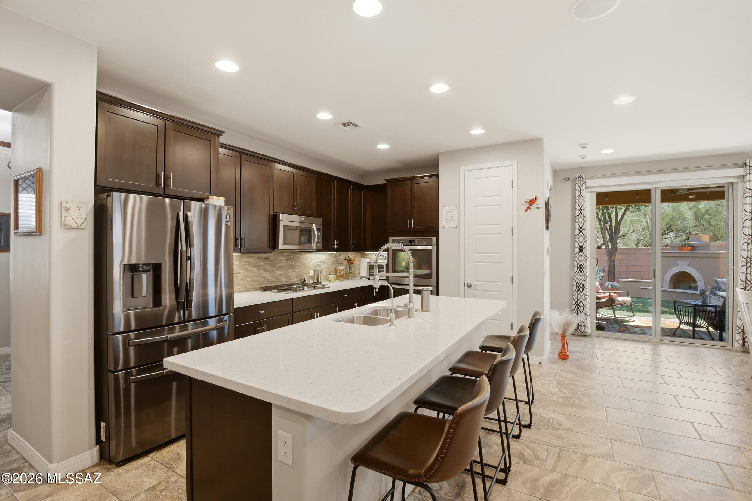 This former Model home became more affordable! Offering a buyer CREDIT of $5,000 that can be used for a rate buy down, OWNED SOLAR, Stunning Sunset Views and a 1 year Home Warranty! SEE IT TODAY!

Welcome to this fully updated single-story home nestled in a secluded pocket of Rancho Sahuarita.

Fully paid-off solar for maximum energy efficiency, this 3-bedroom split-floorplan plus a versatile den/office offers the perfect blend of luxury and functional design.

The beautiful kitchen is a standout feature, tastefully upgraded with soft-close cabinetry, convenient pull-out drawers, reverse osmosis water, premium double ovens, and a brand-new refrigerator. 

The split-bedroom layout ensures maximum privacy for the primary suite, while the open-concept living area flows to the outdoo Step outside into your beautifully landscaped, private backyard oasis. With no rear neighbors, you will enjoy ultimate tranquility and breathtaking, unobstructed Arizona sunset views. Situated in a quiet, low-traffic neighborhood while still giving you access to Rancho Sahuarita's award-winning resort-style amenities including the lake, pools, splash pads, fitness center, and miles of walking trails. This turn-key masterpiece truly has it all! 
Some extra features include a water softener, recessed lighting, ceiling speakers, sound system, epoxy garage floor, solar screens, auto roller shade for backdoor, window coverings. 
Sellers are also offering a 1 year Home Warranty, to give you peace of mind!! See it TODAY!!