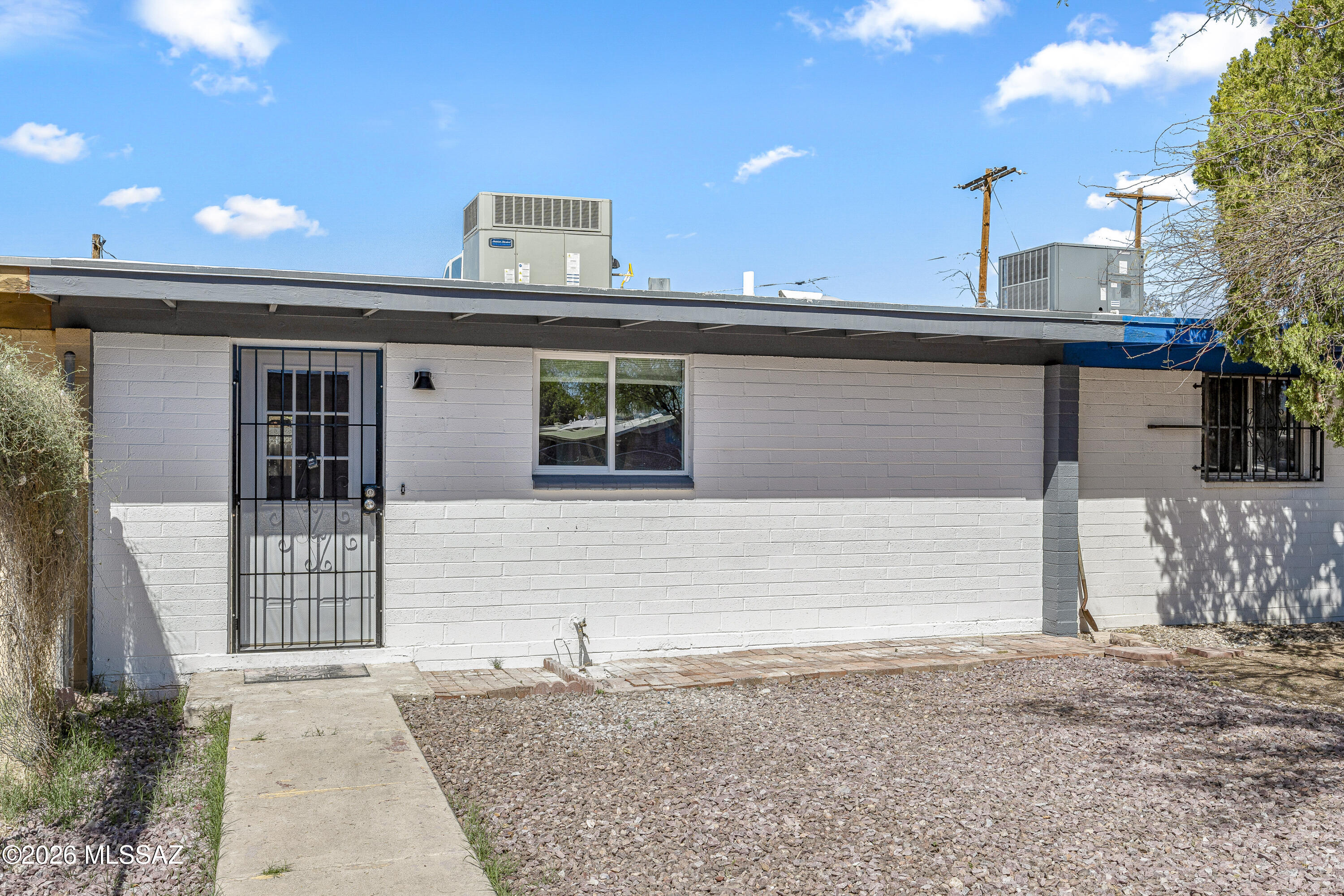 Completely reimagined and move-in ready, this stunning 2 bed, 1 bath home has been taken down to the studs and rebuilt with quality throughout. Enjoy a brand-new AC system, roof, electrical panel, plumbing, and dual-pane windows for peace of mind. The open-concept kitchen shines with new cabinetry, countertops, and stainless appliances. Stylish new bathroom, modern lighting, and fresh finishes throughout create a bright, inviting feel. Step outside to a low-maintenance backyard with pavers and turf--perfect for relaxing or entertaining. A rare turnkey gem!    Principals are licensed to sell real estate in the State of Arizona and one is related to listing agent.