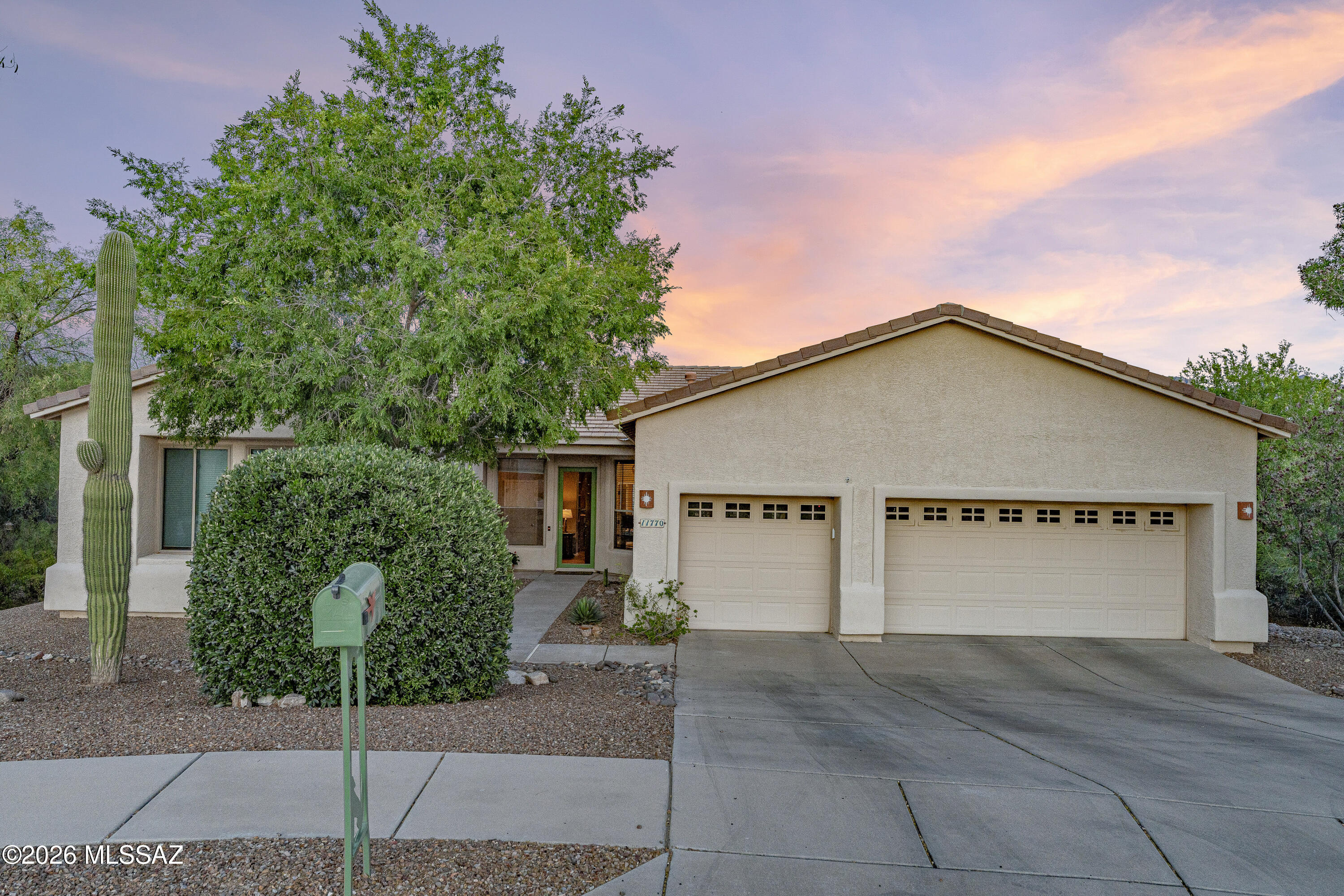 The views are the first thing you notice: stunning mountain scenery, a sparkling pool, and an incredible backyard that make this home feel like a private desert retreat from the moment you walk in.

Tucked away on a cul-de-sac with a spacious, open feel and room to truly enjoy the surrounding landscape, this beautifully maintained home offers the perfect blend of warm Tucson charm and thoughtful updates. The spacious layout includes formal living and dining rooms, plus a welcoming family room with a classic beehive fireplace for cozy desert evenings.

The updated kitchen was designed for both everyday living and entertaining, featuring granite countertops, updated cabinetry, tile backsplash, stainless steel appliances, double ovens, induction cooktop, and reverse osmosis water system - all opening seamlessly to the heart of the home and those unforgettable backyard with mature citrus trees and mountain views.

The primary suite is a true retreat with bay windows, private patio access, a large walk-in closet, soaking tub, dual vanities, and a beautifully updated walk-in shower. Two additional bedrooms share a Jack-and-Jill bath, while the den provides the ideal space for a home office, playroom, or flex space.

Major recent updates include both HVAC systems and the water heater replaced in 2024, along with new front glass doors and patio sliders. Complete with a 3-car garage and located in one of Oro Valley's most sought-after areas, this home combines comfort, character, privacy, and breathtaking Arizona views.