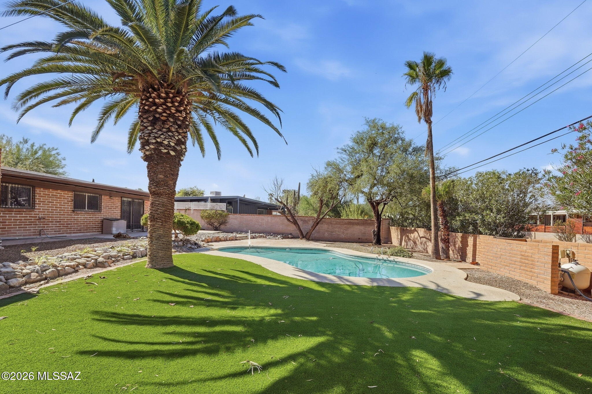 Must See! Specious 4 bedroom, 2 bath home, 2 car carport - situated on a larger lot with pool and lots of privacy.  There is also a patio right off of the living room perfect for relaxing or entertaining. Enjoy the great curb appeal.