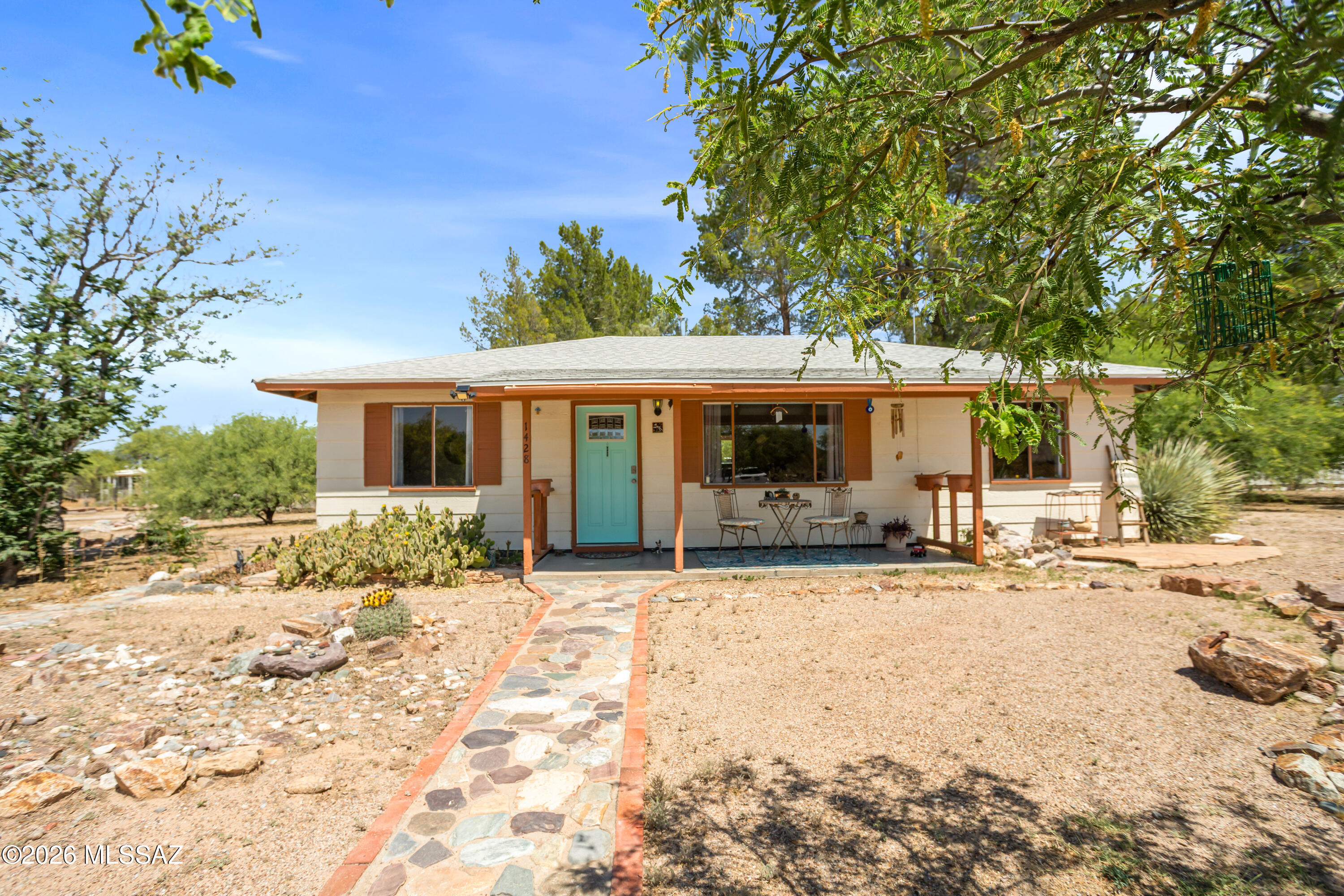 Snowbird's Dream! This high-utility 'lock and leave' property is a rare find. Nestled on nearly a full level acre with 10+ mature mesquites, this home is a private nature reserve for birds and butterflies. Featuring a pull-through site with full RV hookups and an oversized 3-car garage with a 30A workshop. Exceptionally energy-efficient with a brand-new HVAC (<6 months) and sealed ducts, keeping summer bills remarkably low. Inside, enjoy mid-century charm with a vintage 'deli-style' kitchen and formal dining. Updated electrical panel/wiring and 5-stage RO system. Just 2 blocks from the A-rated Pomerene school and 3 miles from I-10 for a fast commute to Tucson or Sierra Vista. Modern utility meets vintage character!