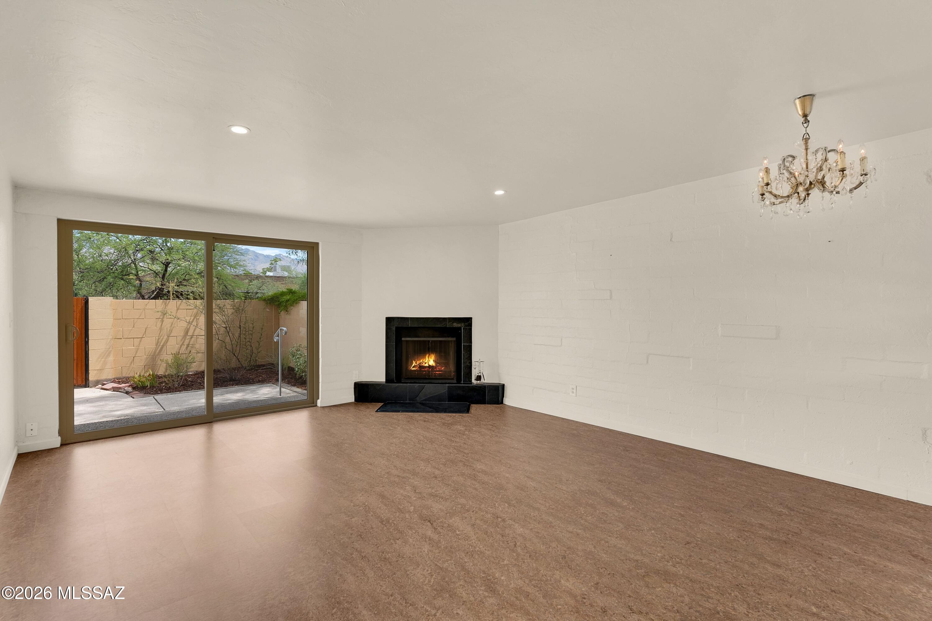 The very best mountain views & the best spot in San Francisco Square condominiums in the Old Ft. Lowell historic district. Meticulously maintained and thoughtfully upgraded. Move in ready. Abundant natural light. Great room with slate fireplace hearth and French Marie Terese chandelier, opens to custom north-facing patio with irrigated desert landscape. Spotless kitchen, newer appliances, Corian countertops, soft-close drawers, custom hand-crafted open shelving and breakfast bar. Marmoleum and tile floors throughout. W/D Convey. Plenty of storage. All newer appliances. Charming courtyard filled with trees and shade. Conveniently located to Natural Grocers, Tucson Medical Center, Plaza Palomino. Option to join Old Ft Lowell Live at Home program. Charm, comfort and Tucson character.