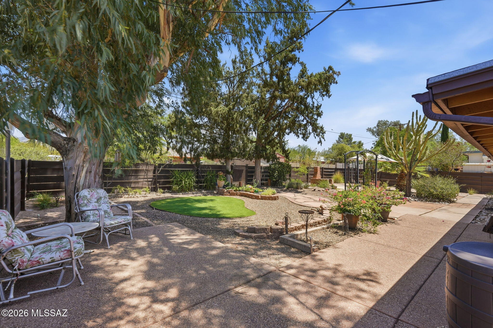 Meticulously maintained, brick home located on corner lot in desirable neighborhood on Tucson's east side.
Three-bedroom 2 bath, glowing with tons of light, additional extra-large great room and mid-century modern fireplace for cozy winter nights. Lush, well designed, low water use landscaping, with well-established trees all on irrigation front and back. Extra-large extended patio with aluminium facia. Hardscaping mixed with desert and greenery. Enjoy the outdoors and mountain views while using the custom-built brick BBQ and fireplace. Relax while viewing an expansive sunset from your beam mounted porch swing. Lots of built-in storage space outdoors and also, an attached indoor work room. Home designed with soft warm palette. New carpet, sturdy tile floors, ceiling fans, updated dual pan windows, security doors and windows throughout. Homeowner recently replaced HVAC, hot water heater, garbage disposal and backyard fence. Short, 2-block distance to elementary school and established neighborhood park. Park features include pool, splash pad, lighted sports fields, pickle ball, covered basketball, tennis courts and an off-leash dog park.
Don't miss an opportunity to be the first to view this impeccably maintained, one of a kind, solid property. This gem won't last!