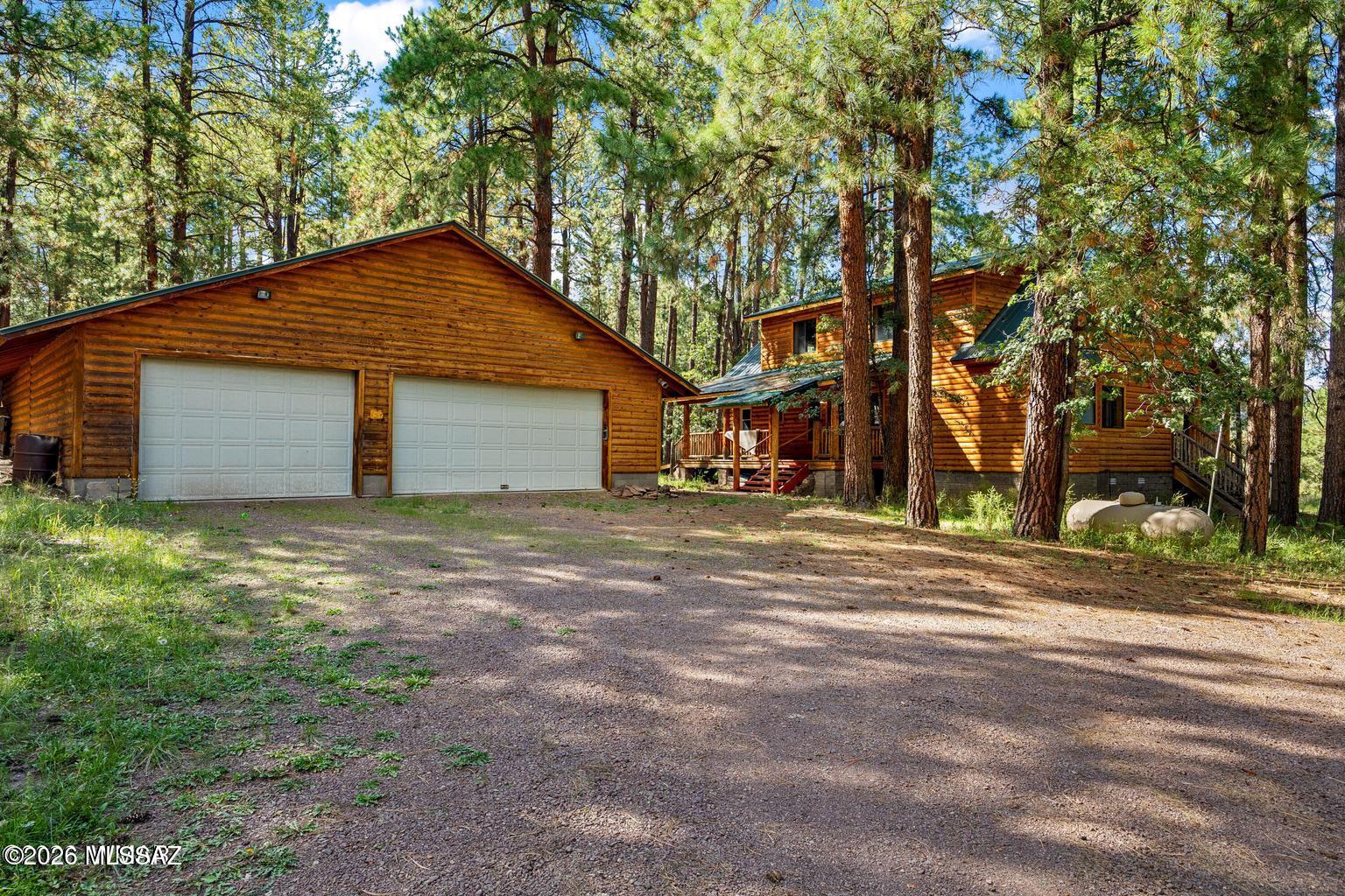 Your Alpine mountain dream starts here--a rustic log cabin with NO HOA, basement, city water and sewer, and an incredible 1,600 sq. ft. six-car garage/workshop for all your toys, tools, and adventures.

Tucked back beneath towering pines in the heart of Alpine, Arizona, this custom log cabin feels like the mountain retreat you've always dreamed about. Built in 2000 and surrounded by peaceful meadow views and abundant wildlife, this special property invites you to slow down, breathe in the cool mountain air, and enjoy true White Mountain living. The home and main improvements sit on 2.86 acres, with an additional 1-acre vacant parcel conveying with the property. NO HOA means more freedom to enjoy your mountain lifestyle your way.
Inside, warm wood floors and classic log-cabin character create a cozy, inviting atmosphere. The great room is centered around a wood-burning stove with HearthStone surround, while the kitchen overlooks the main living area and connects easily to the formal dining space. The main level also features a large primary bedroom overlooking the front of the property, along with a spacious primary bath offering a garden tub with spa features, walk-in shower, and large walk-in closet. A separate utility/mudroom includes a newer washer and dryer.
Upstairs, a HUGE loft opens the door to endless possibilities--game room, hobby space, bunk room, additional sleeping areas, or future bedrooms. The full basement adds even more flexible space and includes a bathroom area ready to be completed.
Step outside and you may find yourself spending as much time on the decks as you do inside. Covered decks along the front, back, and side of the home create the perfect spots for morning coffee, evening sunsets, cool summer breezes, and watching deer, elk, and other wildlife move through the meadow out front.
Need room for all the mountain toys? The detached 1,600 sq. ft. six-car garage/workshop offers exceptional space for vehicles, ATVs, tools, projects, and outdoor gear.
This is more than a home--it is the Alpine lifestyle. Known for world-class hunting and fishing, hiking and biking trails, lakes, rivers, streams, towering forests, and incredible wildlife, Alpine offers adventure in every direction and peaceful mountain living right outside your door. Come experience your own little piece of the White Mountains. Call me for a private showing today.
Main home approximately 2126 sq ft, not including basement.