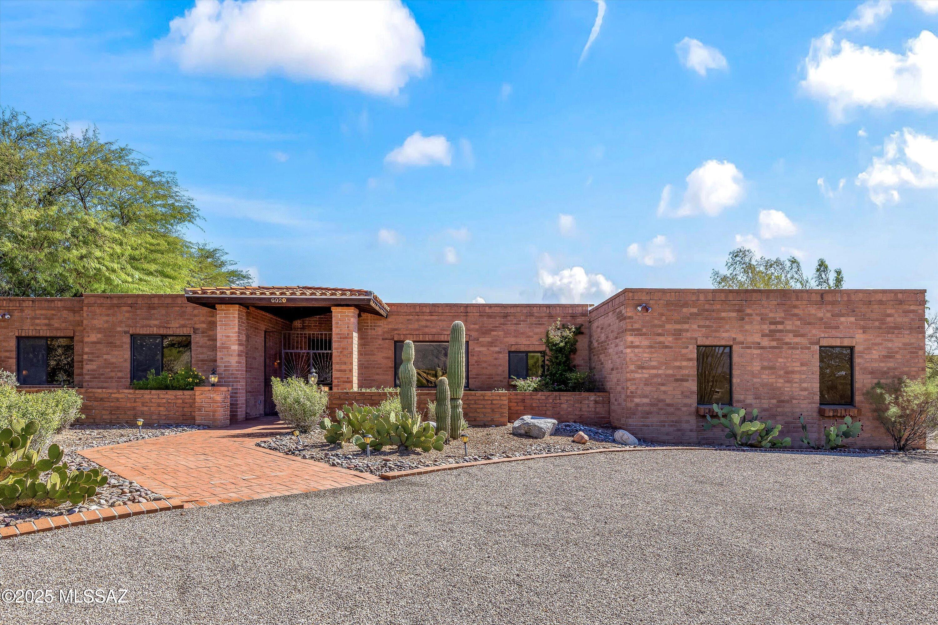 One-of-a-kind Foothills lot with views from every window. New roof! Stunning estate with the views every Tucsonan wants. Mature landscaping and territorial brick design, you won't find another like it. Beamed cathedral ceilings in the main living area give it that warmth and charm. Light and bright island kitchen with quintessential tile counters and over-sized skylight dome. Solid wood interior doors. City views twinkle right from your bedroom window, overlooking the easy-care pool and spa. Built-in grill facing Mt Wrightson. Guest house is steps away, providing 2 bedrooms with a full bathroom, living room and wet bar. High ceilings and plenty of storage are just two of the perks of the guest house. Ice machine in the kitchen! Gas cooktop and wood-adorned hood. Cutting boards are in pristine condition. House shows truly like a gem! 3-car garage with lots of storage. No neighbors across the street. Den could be easily converted into 3rd bedroom by simply adding french doors. Formal dining space plus breakfast far and eat-in kitchen. This home is in impeccable condition, bringing the nostalgia forward to the present to be appreciated. The tilework and like-new cutting boards are so true to the era. Buyer to verify all facts and figures, including those in MLS.