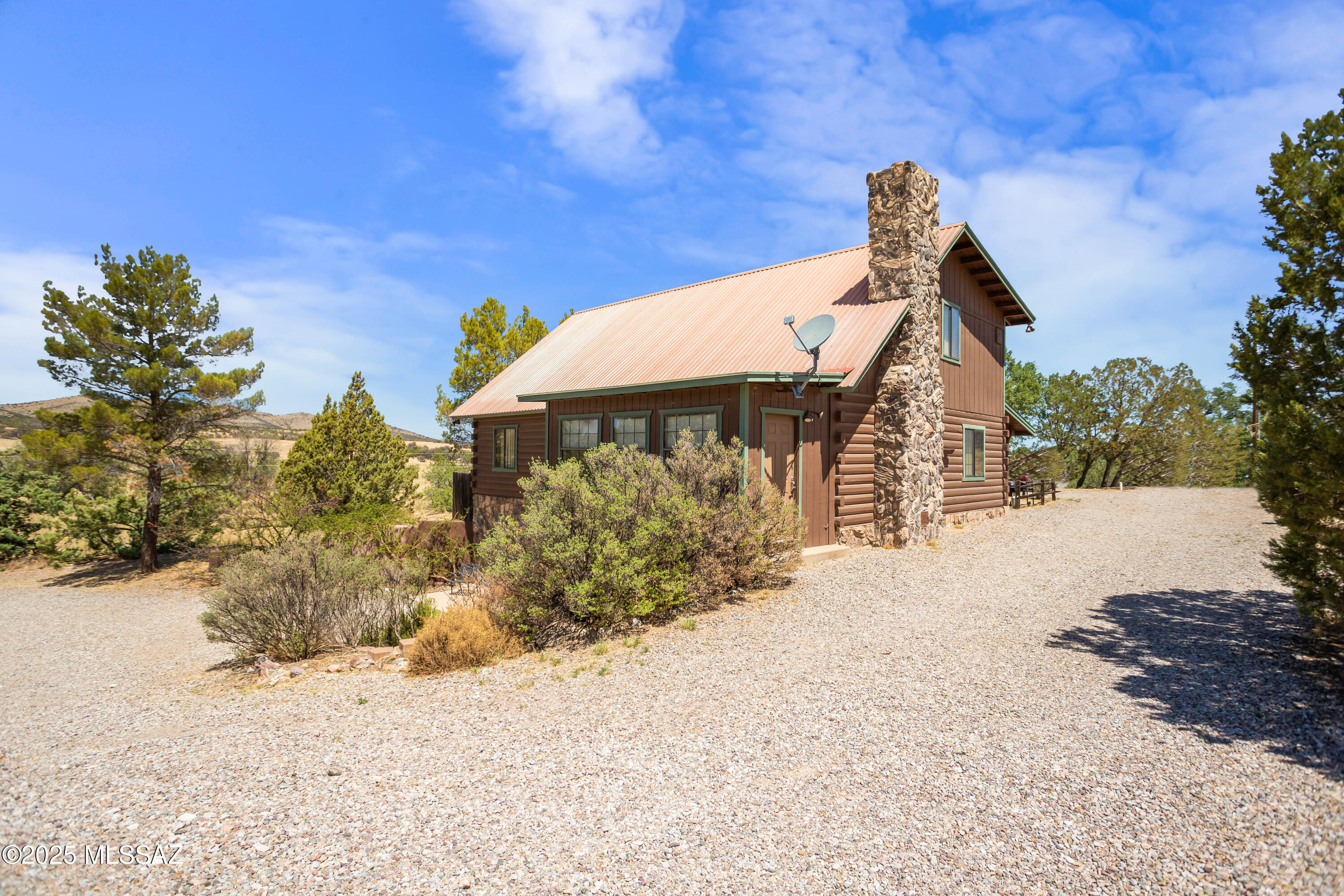 Dreamy Log Home Bordering Coronado National Forest, 5,000' elev & historical Oak trees! 5 Bd 4 Ba, 3181 sq ft. Spacious main living area has an huge stone fireplace, towering ceilings made of timber, generous sized kitchen w/island and separate dining area, two sizable bedrooms & 2 bathrooms. Upper level has a large bedroom, bathroom, a large inviting loft. Lower level has two sizable bedrooms, bathroom, a commercial kitchen (appliances sold separate)  & large storage room, used as income property/BnB w/it's own entrance. The driveway goes up to the main  level as well as lower level for easy access and a  large detached two car garage with shop. Only 10 miles to Parker Canyon Lake, 6 miles to West Gate Fort Huachuca, 9 more to Sierra Vista, 17 miles to Sonoita & Elgin wineries! Must See!
