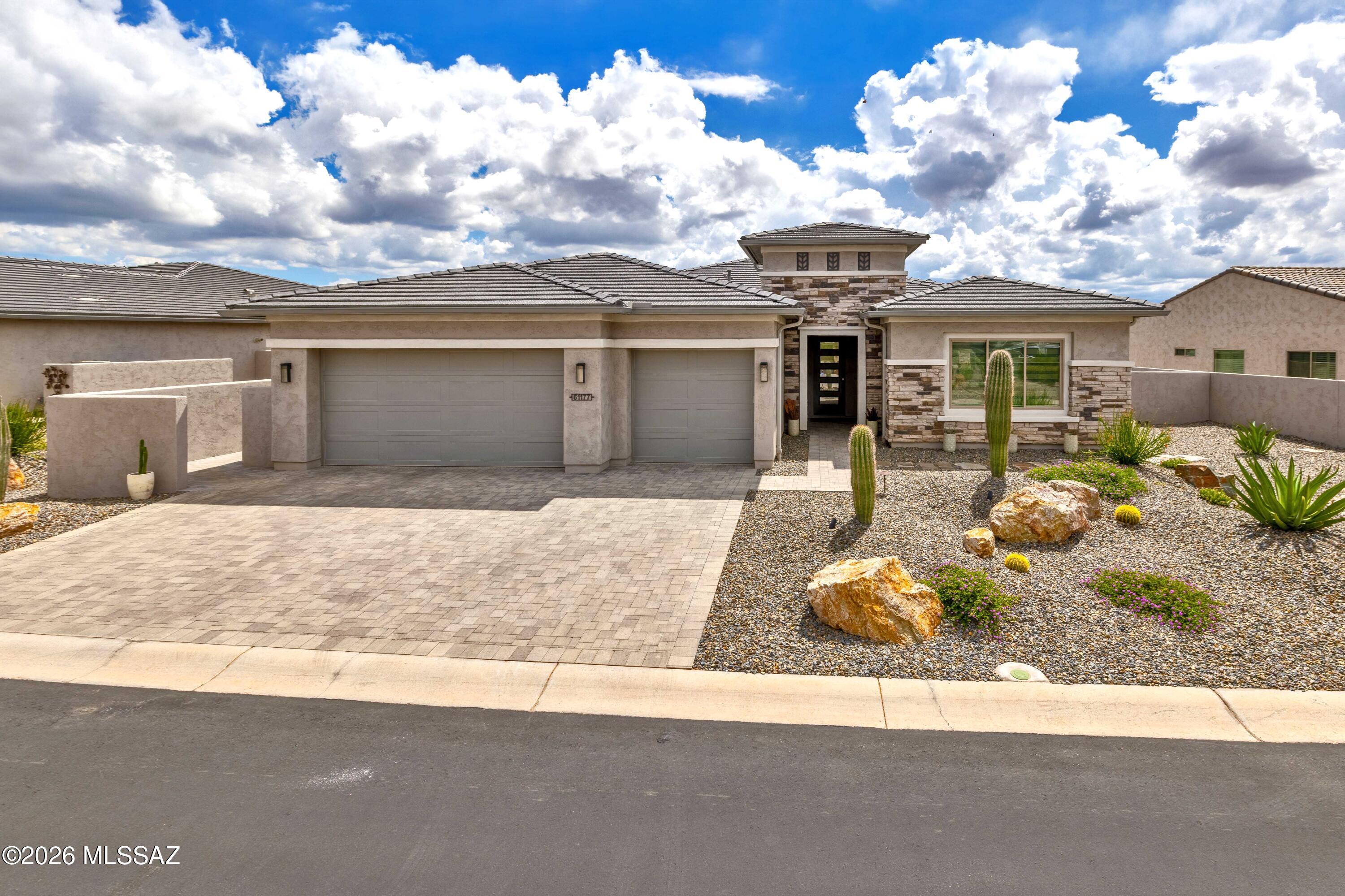 A beautiful 2,387 Sq. Ft. Vienta Exterior Design C Pool home that that was built in 2023 and sits majestically on a raised lot and overlooks an Arroyo that has incredible views of Mount Lemmon.  The home has 2-Bedroom En-Suites, both of which have beeN extended 2-feet; Powder Room; Great Room w/Media Alcove; Entertainer's Kitchen Island; Walk-In Pantry; Spacious Den; Primary Suite has a Walk-In Closet, 42'' X 60'' Curbless Shower w/Seat; Bedroom 2 Suite has a Walk-In Closet; Entry Valer w/Cabinets; Large Laundry Room; Deep 3-Car Garage (extended 4'); 441 Sq. Ft. Extended Covered Patio w/Fireplace, Tucson Rolling Shades, and attached Pergola; and  9', 10' and 11' Ceiling Heights throughout the home. Now let us talk about the backyard! The backyard is majestically designed with travertine pavers, gas fire pit, pool water features w/fire pits,  and artificial grass that surrounds an incredibly beautiful rectangular shaped Pool/Spa with both water features and fire vessels, firepits and the most incredible views of an Arroyo, Mount Lemmon and then the Catalina Mountains.  Welcome to your new home...