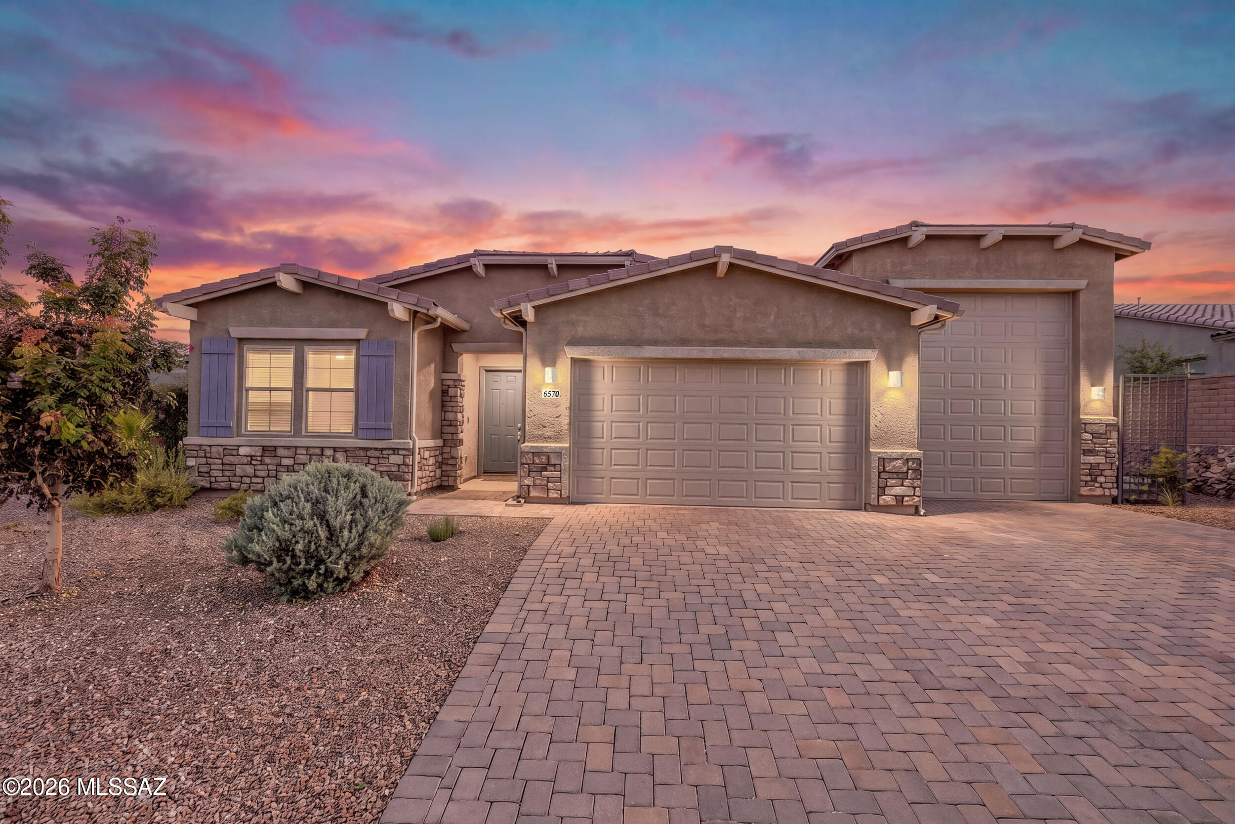 Gated golf community living at Dove Mountain in Marana, AZ near Tucson. This single level 4 bedroom, 2.5 bath former model home was built in 2023 in Los Saguaros at Dove Mountain and sits next to the Golf Club at Dove Mountain, part of the Saguaro Golf Pass. 

Kitchen features include granite counters, stainless steel appliances, and a microwave set into the lower cabinets. RV garage alert: the 3 car garage has the height for an RV, trucks, and toys. The backyard offers an outdoor kitchen, fireplace, water fountain, pavers, and synthetic turf with zero watering, surrounded by saguaros and mountain views. If you are searching for a Dove Mountain home with an RV garage next to the golf course, this one checks every box!