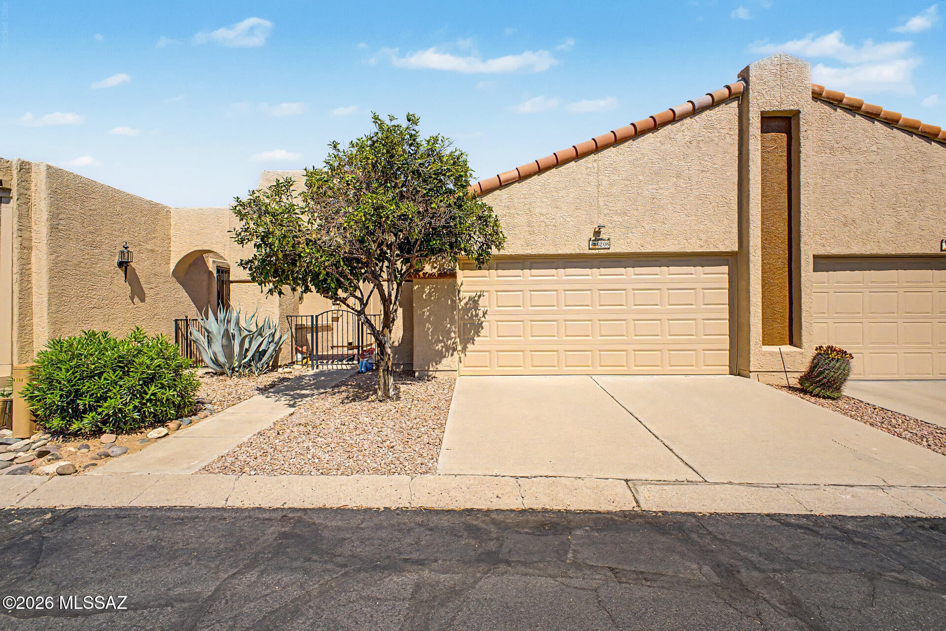 OWNED SOLAR!!! 
Fantastic opportunity to own this beautifully updated 2-bedroom townhome in Sunset Ridge. This inviting home features charming desert landscaping, a private courtyard, stained concrete floors, Santa Fe-style doors, and thoughtful updates throughout. The spacious living room offers a cozy fireplace, skylights, and Pella sliding glass doors with internal shades that fill the home with natural light. The updated kitchen features quartz countertops, wood cabinetry, and stainless steel appliances, plus a water conditioner. The primary suite includes patio access, mirrored closets, and a private ensuite. Enjoy peaceful Arizona evenings in the backyard overlooking a natural ravine. Community amenities include pools/spas, clubhouse, rec center, fitness room, and beautifully maintained common areas. With the warm color pallete and beautiful improvements in every room, this townhome is truly move-in ready!