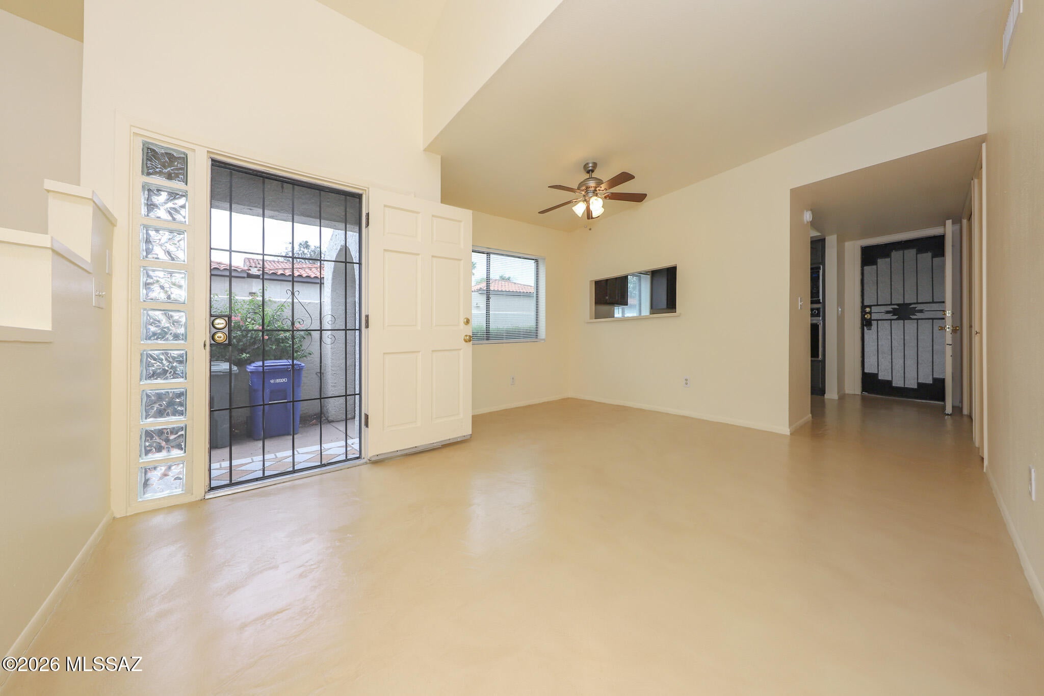 Spacious town home on Tucson's sought after NE side features concrete floors throughout, vaulted ceilings with clerestory windows, and a cozy gas fireplace. The kitchen offers a convenient pass-through to the dining area, wall oven, microwave, and pantry. Laundry closet includes washer and dryer. Primary suite features an ensuite bath with double sink vanity & shower with tile surrounds, walk-in closet, and direct access to the rear yard. Second bedroom also has a walk-in closet. Two-car garage includes a large storage closet and built-in cabinets. Enjoy a low-maintenance backyard with pavers, planters, and covered patio. Community pool nearby plus convenient to shopping, dining & Udall Park offering, walking paths & community classes,