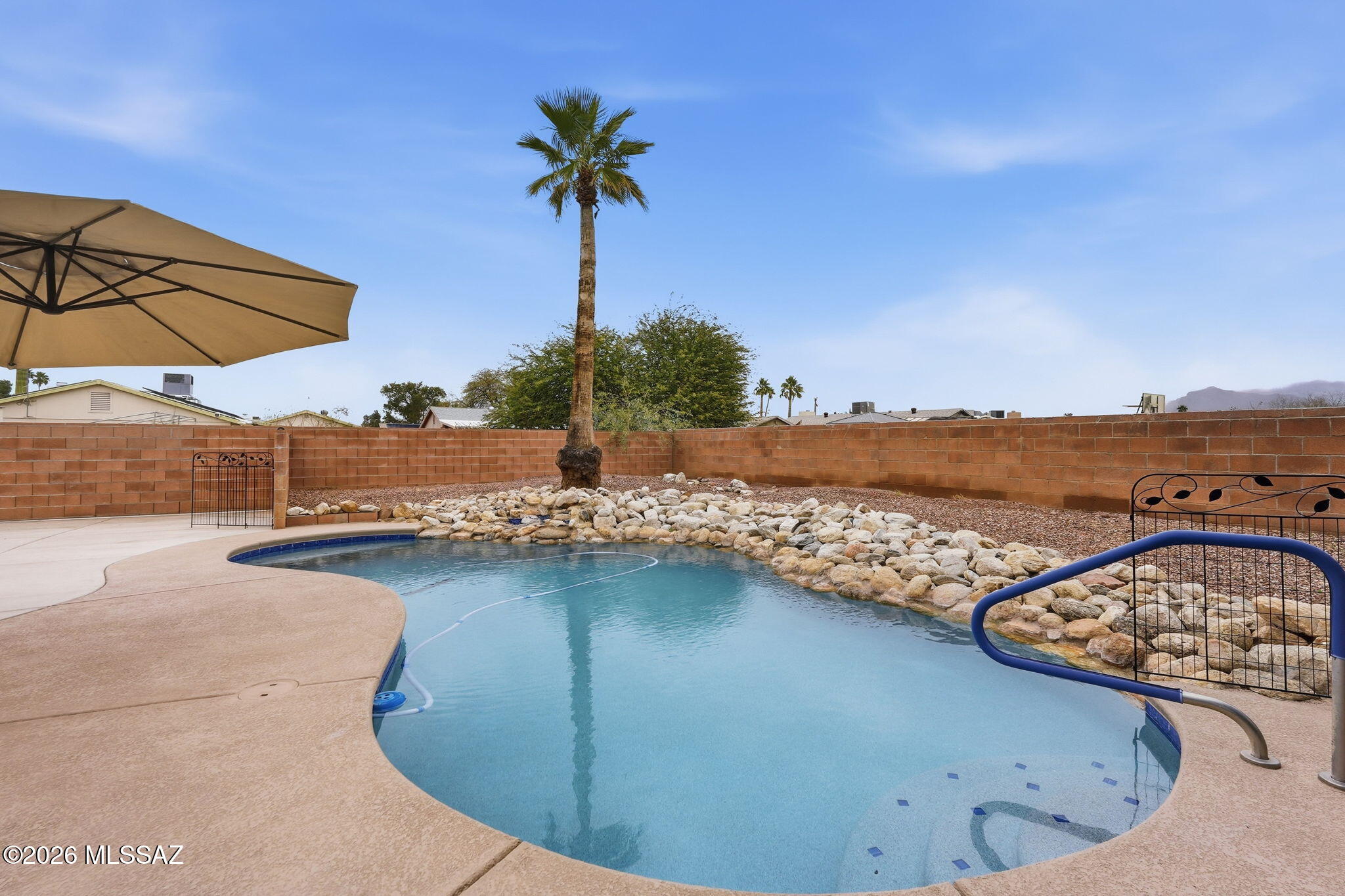 Highly desirable NW Tucson location with updated pool and hot tub! This well maintained 4-bedroom, 2 bath home offers a spacious, comfy layout with tons of upgrades. The kitchen includes stainless steel appliances, and beautiful quartz counter tops with wood cabinets. Seamlessly opens to the main living area, creating an inviting atmosphere. Generously sized bedrooms with the master bedroom providing direct access to the backyard. Step outside to a private backyard retreat featuring a sparkling pebble tech pool and relaxing hot tub, perfect for enjoying Tucson's sunshine year-round. The backyard also offers a large rolling gate for alley access on a huge concrete slab ready for a future detached garage. This home is move- in ready with all the upgrades. No HOA, conveniently located near popular northwest amenities including shopping, dining, parks, and hospitals with easy access to I10.