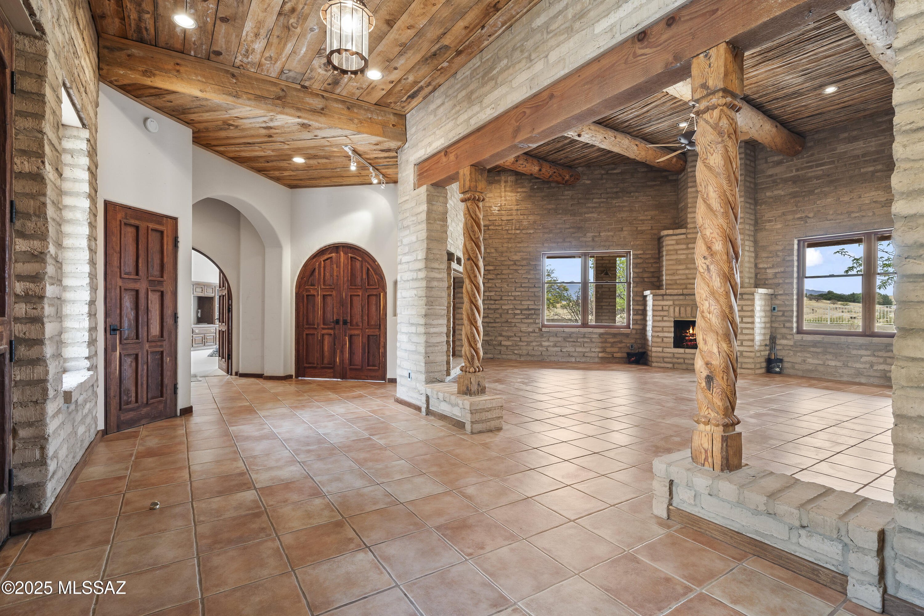 STUNNING Authentic ''Mud Adobe' Hacienda w/Striking features throughout. Built on 12'' torsion bar tension slab w/16'' adobe ext. walls.  Great Rm w/ High saguaro ribbed ceilings, 16'' hand hewn viga beams, 2 fireplaces & built-in wet bar. Chef's kitchen boasts Granite island, prep sink, commercial grade appliances, Sub Zero Refrig., Viking dual gas stove, double ovens, Antique cook stove & solid Mesquite wood flooring. Marble counters tops in R/R, walk-in shower & Huge walk-thru closet.  Home office w/hand peeled latillas ceiling & solid mesquite flooring w/solid wood doors. Custom built 42x52 4 door block SHOP w/ RV bay, work counters. Great private well w/new pump/pressure tank put in 2024. New Int. paint in primary suite, Roof warranty at home & shop. Amazing MTN views, u/g power, Wow