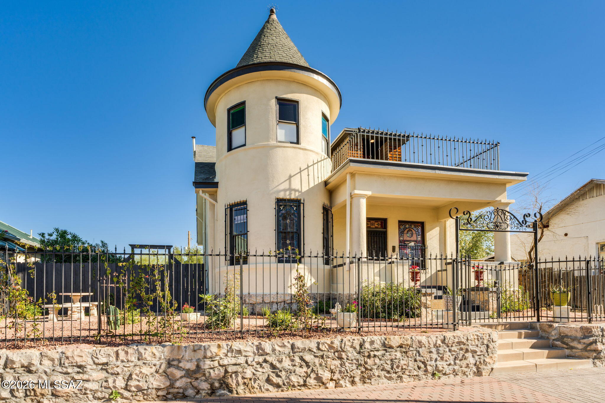 Can you picture yourself staying in this remarkable home as a luxury short-term rental in the heart of Tucson - where historic charm meets modern comfort in an unforgettable setting? Meticulously restored Queen Anne-era residence originally constructed in 1910, this extraordinary property seamlessly blends historic grandeur with modern livability. The thoughtfully reconfigured floor plan was designed to meet the needs of today's lifestyle while honoring the home's original architectural integrity. Much of the original stained glass has been carefully preserved, complemented by beautifully restored wood floors and distinctive architectural details that exemplify the craftsmanship of the early 20th century. This truly one-of-a-kind home was originally built for Peter and Mary Ziegler, with Peter Ziegler recognized as Tucson's first railroad engineer. The property is located in the historic Iron Horse District, an enclave established for Tucson's earliest railroaders, adding rich historical context and provenance that cannot be replicated.
The home has undergone a comprehensive restoration, including new electrical, plumbing, and HVAC systems. Additional upgrades include five mini-split systems upstairs for enhanced comfort, sound-reducing flooring on the upper level, and numerous other thoughtful improvements that ensure modern efficiency without compromising character.
Offering four bedrooms and four full bathrooms, the property also features ample storage and a basement; rare and valuable attributes for a home of this era. The grounds are fully landscaped, showcasing original brick pavers in the front yard that further highlight the home's historic charm. The oversized rear parking area, secured by an automatic gate, accommodates up to six vehicles an exceptional feature for a historic property.
A beautifully paved side yard provides a versatile outdoor space ideal for gatherings and entertaining, offering endless possibilities for enjoyment. This exceptional residence stands as a masterful restoration of Tucson history, combining timeless elegance, modern comfort, and unparalleled character.