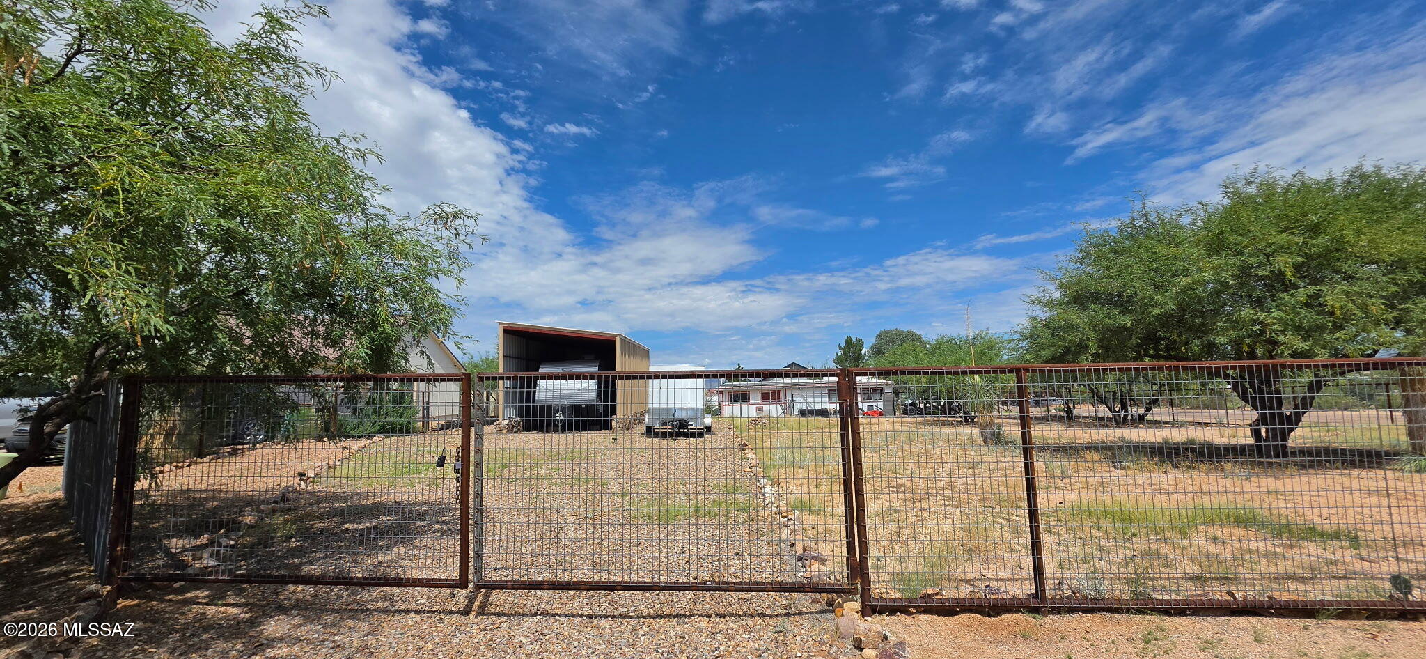 BEAUTIFUL CORNER LOT FULLY FENCED WITH 15x24 METAL RV STRUCTURE. POWER, WATER, SEWER & GAS AT LOT LINE. CLOSE TO INTERSTATE 10 WITH EASY ACCESS TO TUCSON AND SIERRA VISTA. PERFECT FOR YOUR SITE BUILT HOME. NO HOA! ENJOY THIS ESTABLISHED NEIGHBORHOOD LOCATED IN THE HIEGHTS OF BENSON. APPX 3600 FT ELEVATION. ZONED R-1-8 CITY OF BENSON.