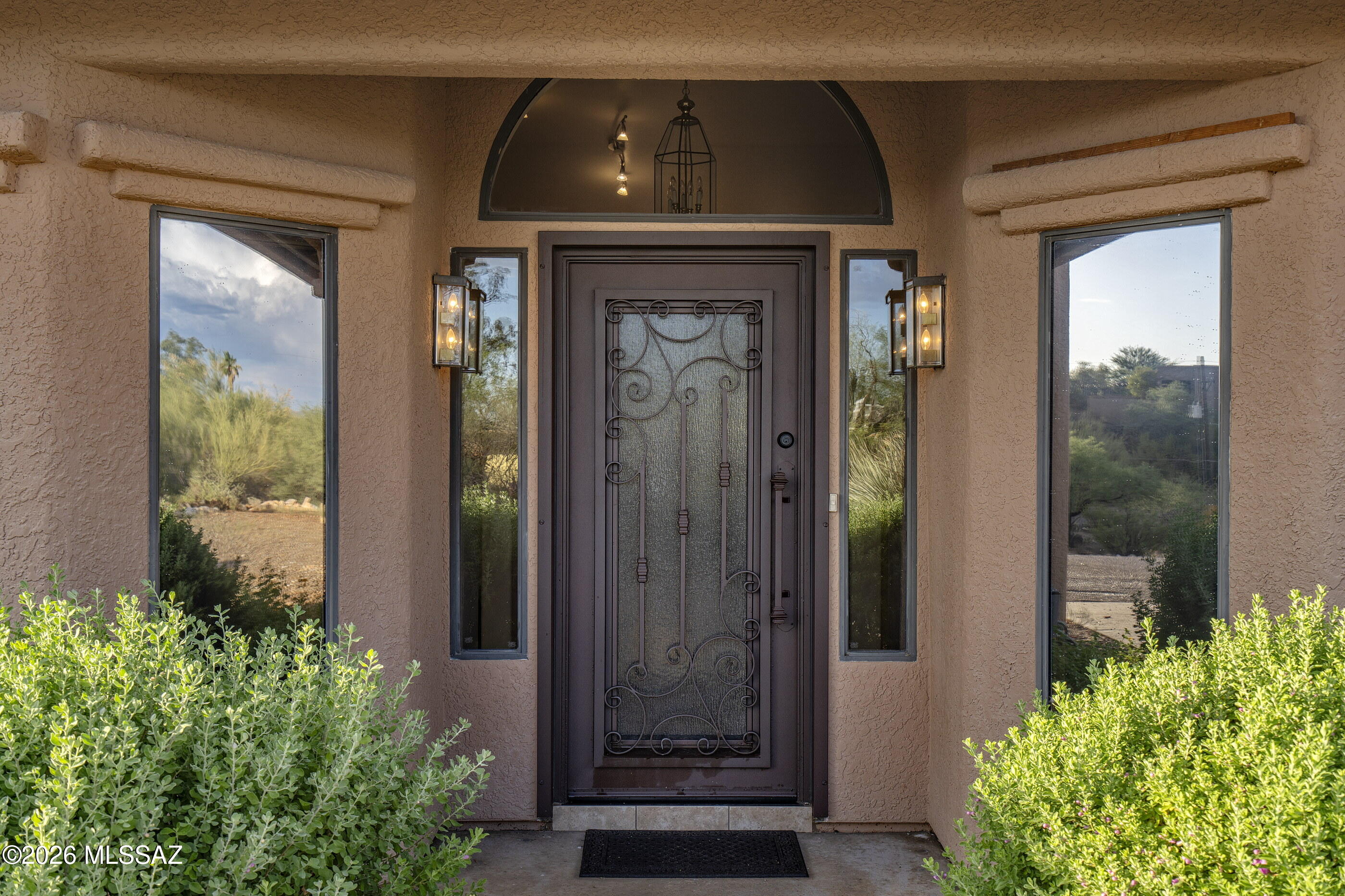 Spectacular Catalina Mountain views set the stage for this beautifully maintained 4-bedroom, 2-bath home situated on nearly 2 private acres in prestigious Flecha Caída Ranch Estates. A beautifully appointed kitchen features granite countertops, stainless steel appliances, abundant cabinetry, & opens to a spacious family room with a cozy fireplace--perfect for everyday living and entertaining. A formal living room & formal dining room provide additional space for hosting family and friends. The split-bedroom floor plan offers privacy, w/generously sized bedrooms throughout. The home has been well maintained & is ready for its next owner to make it their own. Step outside to enjoy breathtaking mountain vistas from your own backyard. NEW Bullfrog Jaccuzzi conveys w/home. A three-car garage provides ample space for vehicles, storage, hobbies, or a workshop. This exceptional property combines spacious living, gorgeous views, and an outstanding location in one of Tucson's most desirable acreage communities. Whether you're looking for peaceful desert living, room for your recreational vehicles and hobbies, or simply a home with incredible scenery, this is a rare opportunity you won't want to miss. NEW garage door. Storage throughout home.  Don't miss the viewing deck on top of the 3rd car garage!  Panoramic Views!  3rd car garage currently being used as workshop - but, could easily be used for an office, exercise room, storage, or a garage.  Solar is owned.