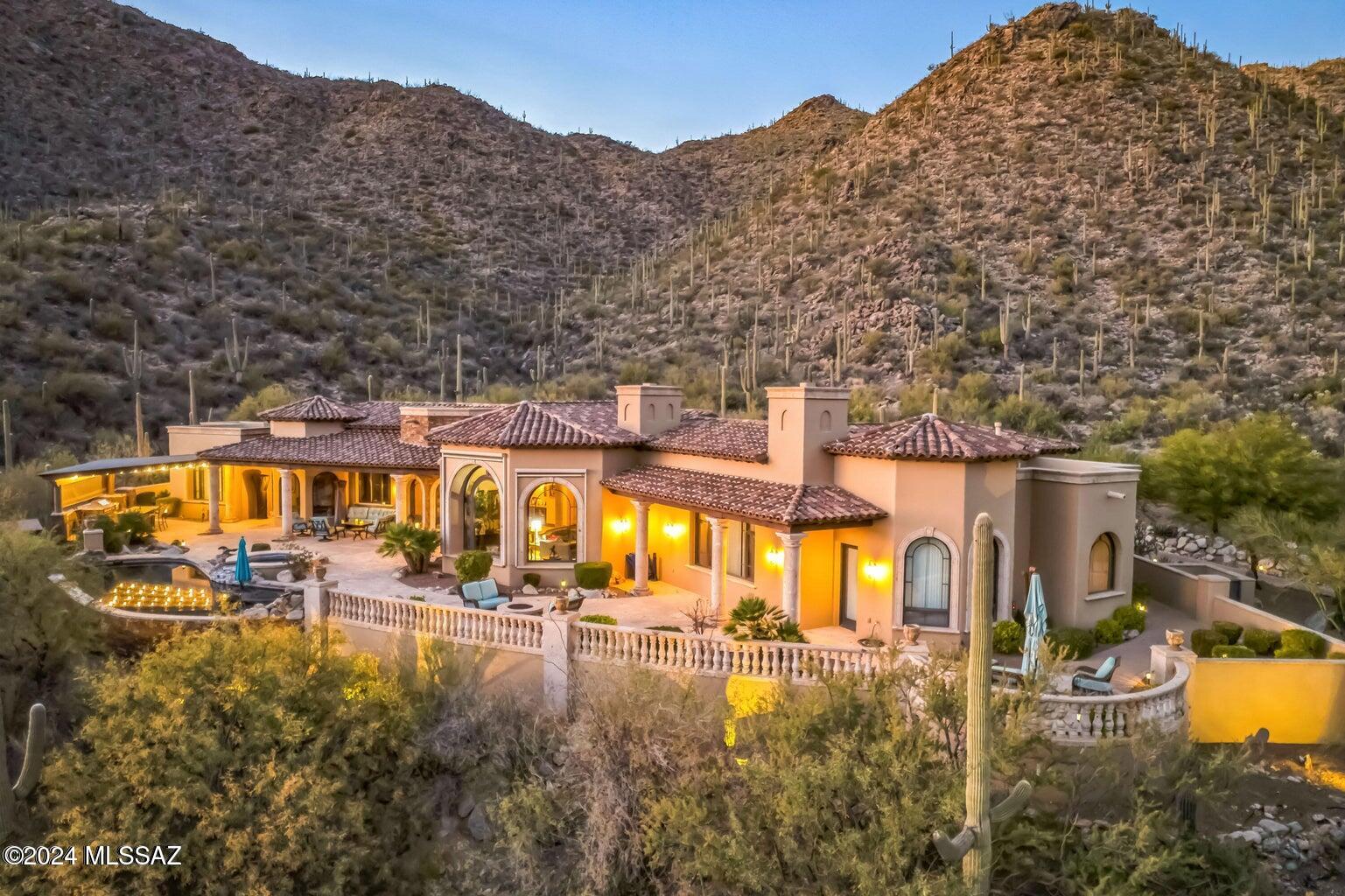 Nestled in depths of luxurious guard gated Canyon Pass at Dove Mountain, one will experience a higher level of luxury w/unrivaled quality & extravagant amenities. Masonry construction w/stone & wood -touches of Mediterranean style + Southwest Contemporary highlights. Elegance w/modern style wonders that showcase bold style and engaging design. The residence promises to redefine your concept of luxury living, offering an exquisite blend of elegance, comfort & unparalleled craftsmanship. Meticulously crafted by Alan Roberts w/interiors by Lori Carroll, this architectural marvel ''lives'' in the dramatic Southern Arizona landscape. Perched on 1.5 acres, the estate boasts panoramic views of soaring saguaros and mesmerizing Tortolita Mountain ranges + a12ft handcrafted metal front entry door.