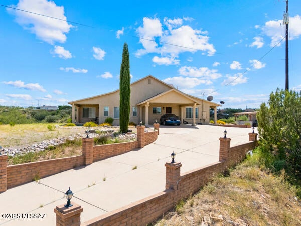 Exterior Just Painted! ''Nestled on a hilltop in Central Rio Rico, this charming home offers a spacious yard, stunning views, and exceptional privacy--perfect for relaxation. Inside, the kitchen features custom cabinetry, granite countertops, stainless steel appliances, and a center island. Ceramic tile flows through most of the home, complemented by upgraded wood shutters. The generous primary suite includes laminate flooring and a jetted tub for ultimate comfort. Recent upgrades include Saltillo tile on both the front/ back porches, Storage shed, newer AC and newer roof. Conveniently located near Ruby Road and I-19, this home combines style, comfort, and accessibility.''