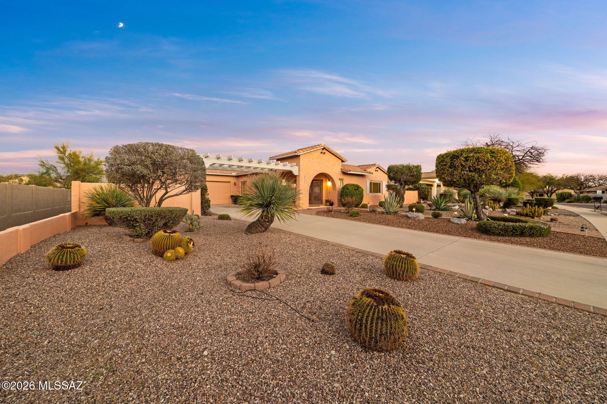 Rare courtyard-centered home in Oro Valley built with solid masonry construction by David J. Baird, designed for peaceful indoor-outdoor desert living. The home is centered around a private courtyard with water feature, where French doors, sliders, and sun-filled windows from multiple rooms create seamless indoor-outdoor flow.

The flexible floor plan offers approximately 2,350 square feet with two bedroom en-suites, including a front guest suite with convenient dual-access bath. The inviting family room features an architectural honeycomb fireplace, adding warmth and character to the home's living spaces.

The spacious primary suite offers a garden soaking tub with beautiful views, creating a peaceful retreat, while the second ensuite bedroom enjoys Catalina Mountain views. Multiple rooms overlook the tranquil courtyard, bringing natural light and a sense of calm throughout the home.

Outdoors, enjoy mature grapefruit, lemon, and orange trees, beautiful desert landscaping, and a natural desert backdrop that enhances privacy and highlights the authentic Sonoran Desert setting. A pergola-covered extended driveway and view fencing with snake fencing installed add thoughtful outdoor features.

Located in desirable Rancho Vistoso near the neighborhood park with playground, basketball, and volleyball courts, this home captures the relaxed desert lifestyle that makes Oro Valley so special.