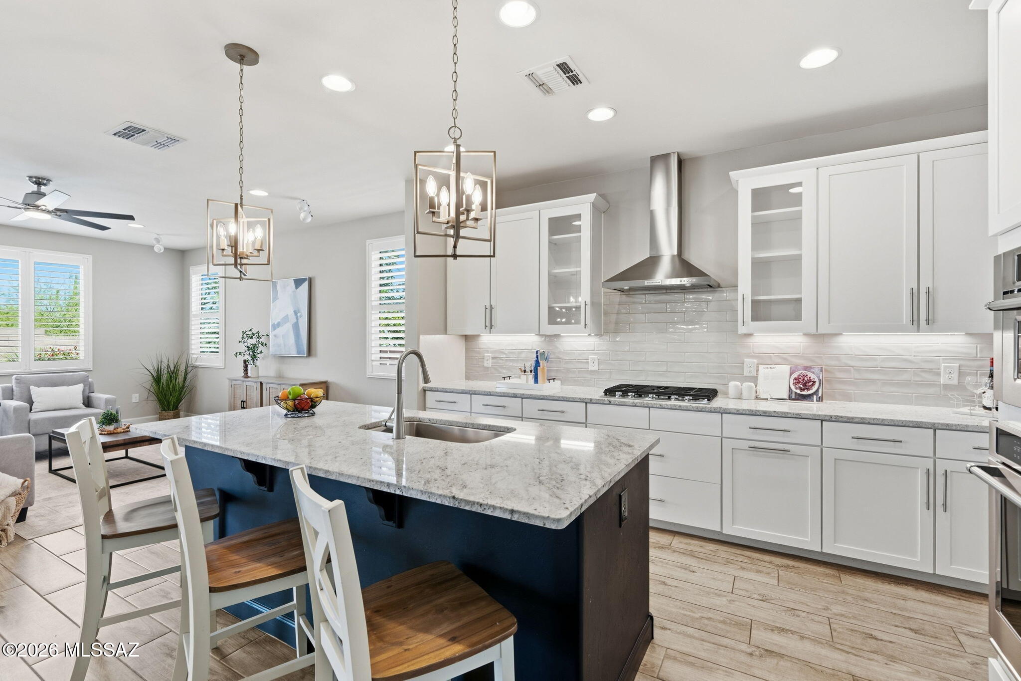 This beautifully maintained 2020 residence, thoughtfully enhanced with stylish upgrades and perfectly positioned to capture Catalina Mountain views. From the moment you enter, you'll appreciate the bright, inviting great-room design, elegant finishes, and plantation shutters throughout. The stunning kitchen is the heart of the home, featuring crown molding, granite countertops, stainless steel appliances, a gas cooktop, tile backsplash, pendant lighting, and a spacious center island with breakfast bar. A large pantry, charming coffee bar, and dedicated desk area add both convenience and functionality. The adjoining dining area showcases custom decorative wall paneling and sliding glass doors that open to an exceptional east facing backyard retreat. Enjoy outdoor living under the covered patio, with attractive pavers and low-maintenance artificial turf creating an ideal space for relaxing or entertaining. The lot backs to a common area, providing an additional sense of privacy and an open backdrop.

The generous primary suite offers a peaceful retreat with dual vanities, a walk-in shower, and a spacious walk-in closet. Beautiful ceramic tile is thoughtfully placed throughout the home, complemented by abundant storage and quality finishes.

Ideally located in Northwest Tucson, this exceptional home offers convenient access to schools, shopping, dining, golf, and everyday amenities. The neighborhood park is just around the corner, adding to the appeal of this wonderful community.

Immaculately cared for, beautifully upgraded, and enhanced by Pusch Ridge views and a private-feeling backyard, this home is truly move-in ready and ready to welcome its next owner.