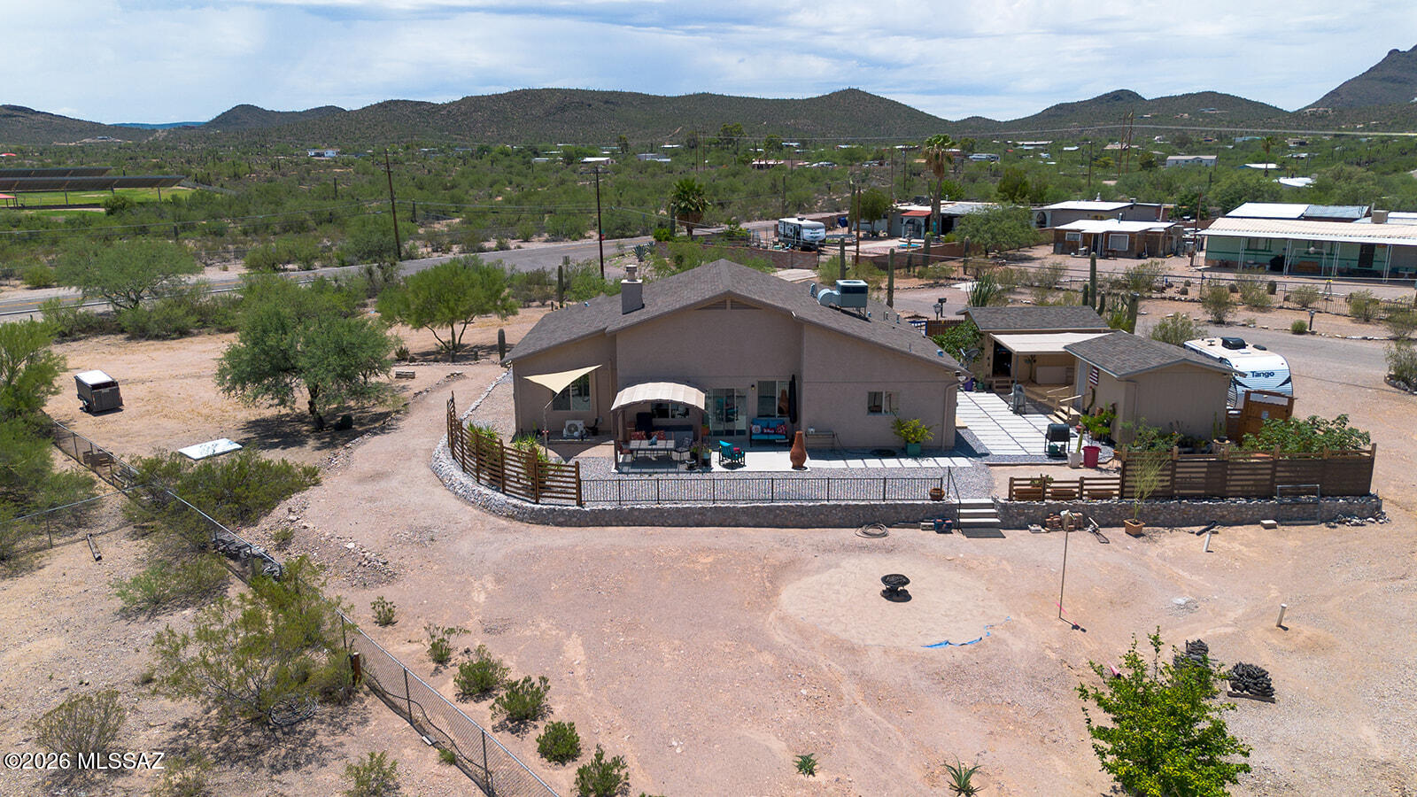 This place is an absolute rare find. Built in 2015, the home sits on a huge 0.93-acre corner lot with MH-1 Zoning and no HOA, giving you tons of freedom with your Lot. Incredible views of both the city and the mountains. Outside features include landscaping gravel, a clean concrete walkway, and a solid retaining wall that adds major curb appeal. Plus, plants and Shrubs. The property is packed with potential. Two permitted 12x16 detached sheds can easily be finished into guest suites, offices, or extra bedrooms. The garage/workshop can also convert into a 3rd bedroom. Inside, four added mini-splits mean you rarely touch the main AC, keeping power bills low. Plus, it is completely ready for your RV with a 50-amp plug and dedicated septic hookup. This place is a rare find with endless options