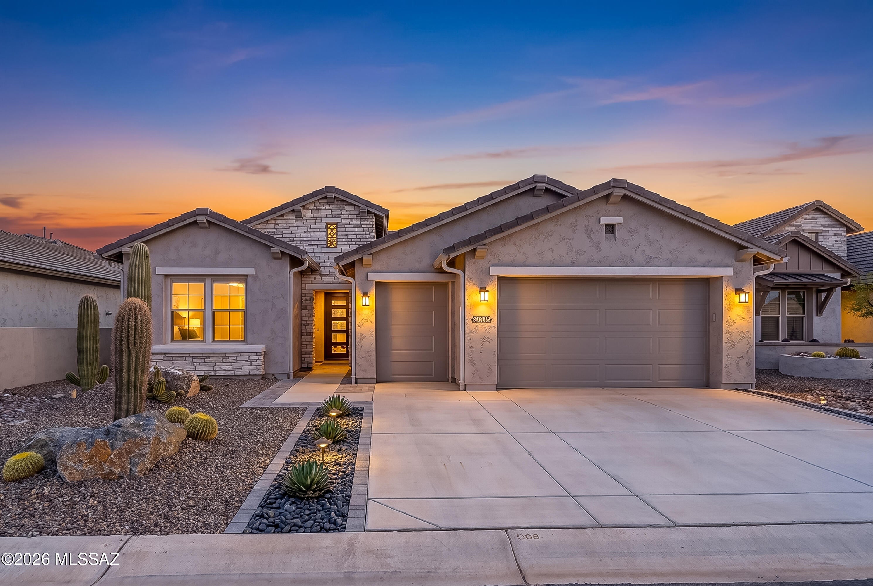 From the moment you enter, you'll appreciate the clean architectural lines, contemporary finishes, and bright, open-concept design. The showstopping kitchen is the heart of the home, featuring dramatic natural quartzite countertops, upgraded stainless-steel appliances, sleek cabinetry, generous workspace, and an inviting layout designed for both everyday living and effortless entertaining.
The spacious primary suite provides a peaceful retreat, complemented by a striking spa-inspired bathroom with dramatic black quartz countertops accented by elegant white veining. Quartz surfaces in the additional bathrooms continue the home's cohesive, elevated design. A private guest suite offers exceptional comfort for visiting family and friends, while the separate den provides the perfect space for a home office, media room, or quiet retreat.
Step outside to enjoy the fully fenced backyard, covered patio, beautiful desert surroundings, and mountain views--an ideal setting for morning coffee, evening cocktails, and Arizona's spectacular sunsets. Smart-home features and a water-filtration system add modern convenience, while the golf cart bay provides valuable additional space for your golf cart, recreational equipment, or storage and an installed Level 2 EV charger provides convenient at-home charging for electric vehicles.
Located within SaddleBrooke Ranch, residents enjoy an extraordinary resort-style lifestyle with golf, pickleball, tennis, bocce ball, indoor and outdoor pools, fitness facilities, dining, social clubs, creative arts, and countless opportunities to connect and stay active. Why wait to build when this barely lived-in, highly upgraded Alora is ready to enjoy? Modern, sophisticated, and beautifully appointed--this exceptional home is the complete SaddleBrooke Ranch package!