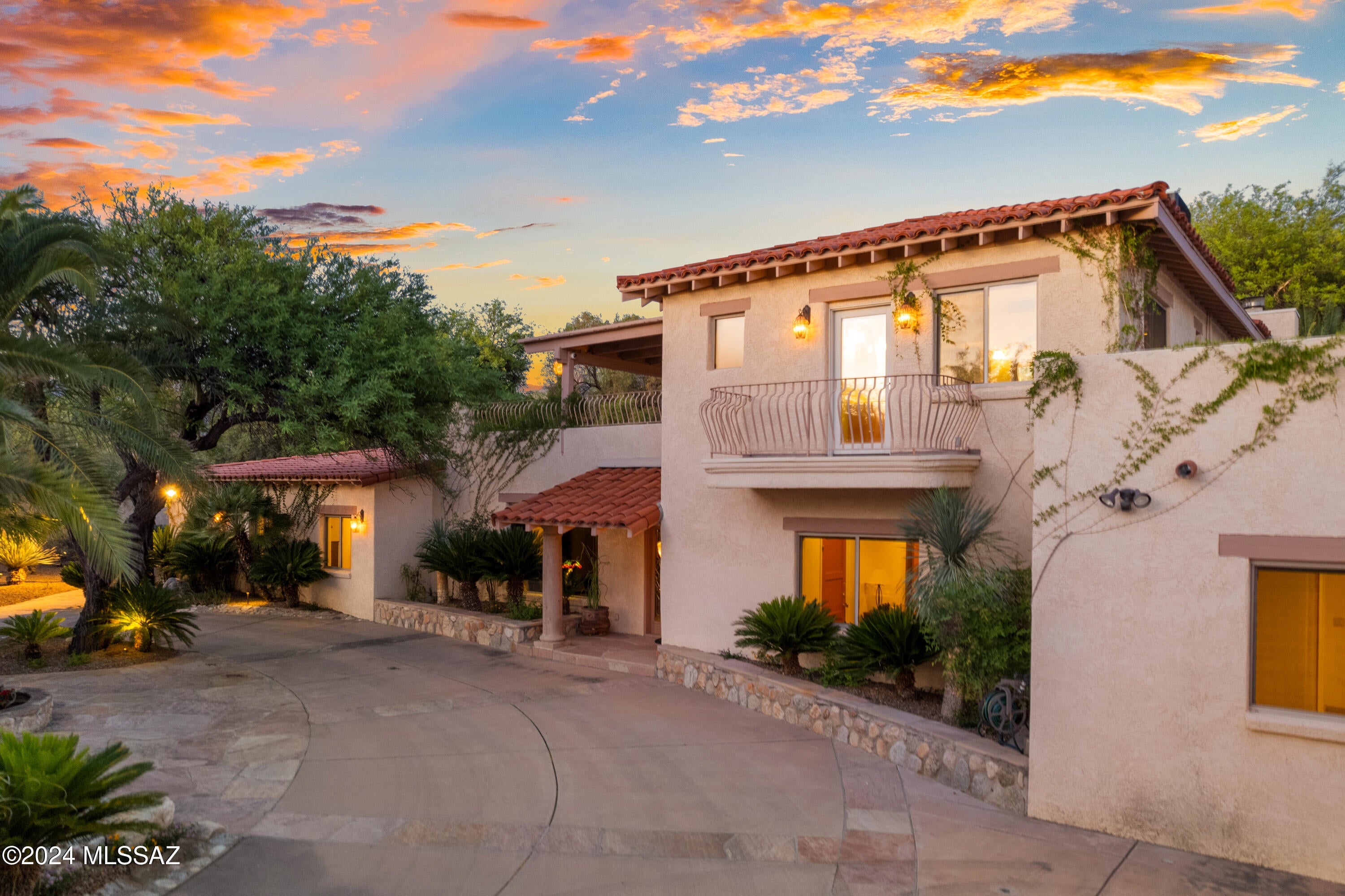 Seller will accept or counter offers between $1,495,000 and $1,695,000. Designed in a Mediterranean style, you'll enter the breathtaking grounds through a private gate and a circular driveway with a soothing water feature and a spacious five-car garage that enhance both its aesthetic appeal, privacy and functionality. Once inside this extraordinary Tucson home, discover the epitome of luxury living, where every detail has been thoughtfully designed to create a haven of peace and sophistication. This ''oasis in the desert'' offers a serene Tuscan-style sanctuary with the convenience of local shopping, dining and entertainment right at your fingertips. The interior of the home boasts exposed beam ceilings that add to its rustic elegance. Adorned with a rich color scheme and luxurious finishes, this home is highlighted by two separate living spaces, a cozy library and four adobe brick, cantera stone and travertine fireplaces. The chef's kitchen is a culinary dream, equipped with professional-grade appliances and a spacious island complete with a breakfast bar, prep sink and wine refrigerator and a spacious island complete with a breakfast bar, prep sink and wine refrigerator. Enjoy music in every corner of the house with the integrated sound system, perfect for setting the mood for any occasion. All bathrooms feature travertine floors, counters, and surrounds, with separate jetted tubs in both master baths. Each bedroom has custom-designed walk-in closets, ensuring ample storage and organization. The back yard is an absolute dream, lush and green with an extended patio, in-ground pool and spa with waterfall, transporting you to a tropical paradise without leaving the comfort of your home. This unique estate is a definite must-see!
