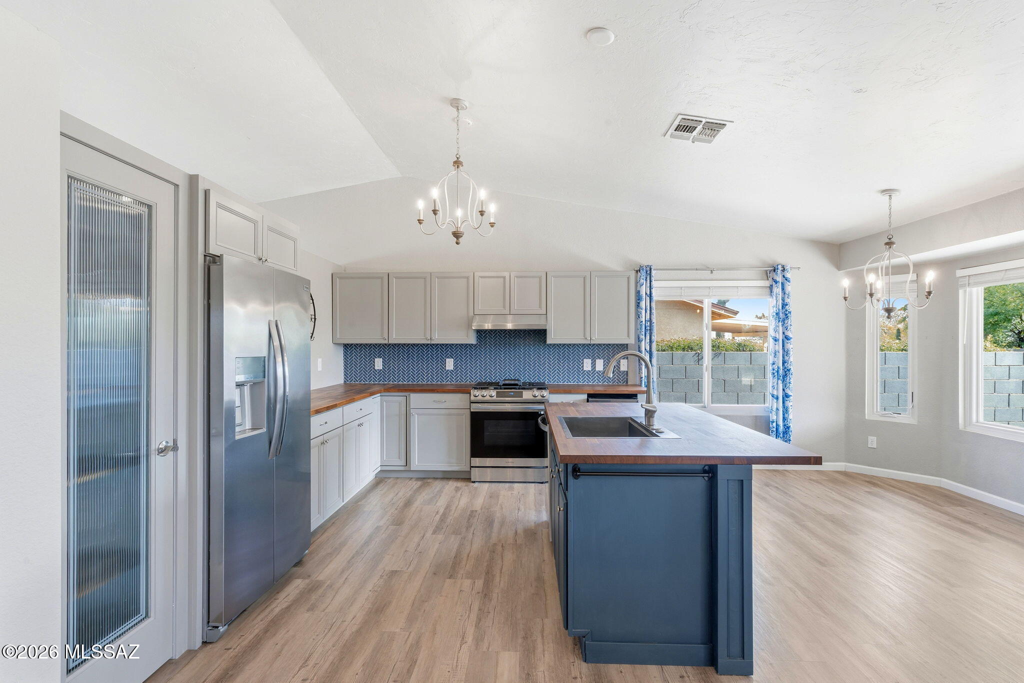 Positioned at the end of a quiet cul-de-sac in Rita Ranch within the award-winning Vail School District, this beautifully upgraded home offers privacy, no rear neighbors, and stunning Rincon Mountain views. Inside, refined wood-look luxury vinyl plank flooring flows throughout, complemented by a bright, modern kitchen featuring new cabinetry, appliances, and butcher block countertops. The adjoining family room with a cozy fireplace creates an inviting space to gather. The primary suite offers an updated bath with a newer vanity and flexible bonus space. With a newer roof, upgraded plumbing, brand-new windows, a spacious backyard, and a nearby community park, this move-in-ready home delivers comfort, style, and quality living. Seller will accept, or counter offers between $325k and $340k.