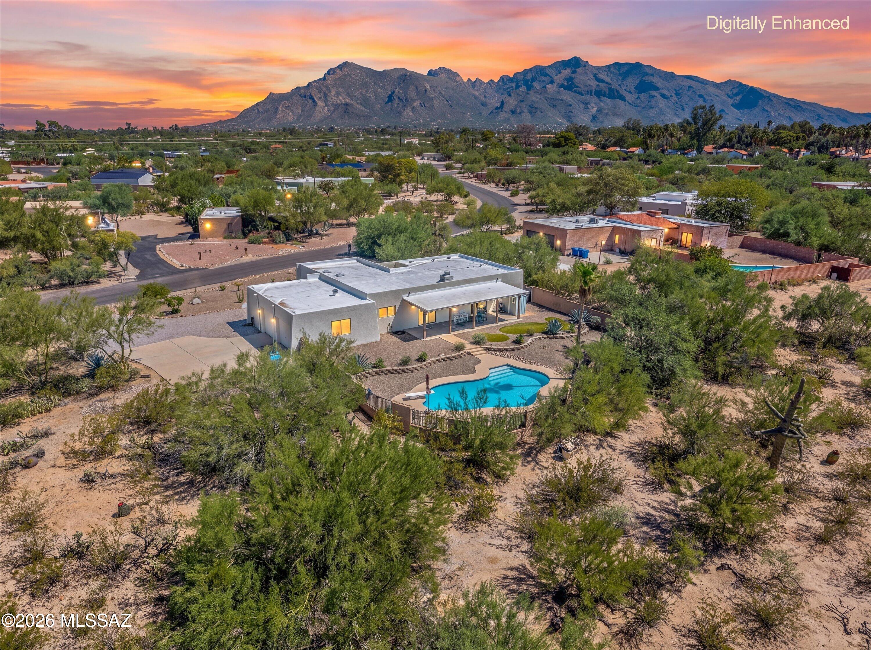 Updated & modern Territorial-style home located in Northwest Tucson's desirable Sahara Palms community. This stunning property sits on a spacious .85-acre lot with NO HOA, offering plenty of room for an RV, additional garage, casita or other possibilities. The inviting floorplan features a large family room with beehive fireplace, dining area, breakfast nook, laundry room and versatile den/office space. The chef's kitchen showcases granite countertops, knotty alder cabinetry, island with breakfast bar, tile backsplash and stainless steel appliances. Spacious primary suite offers a private patio sliding glass door, walk-in closet, dual vanity and remodeled walk-in shower. The backyard is a true oasis with an extended covered patio, sparkling pool recently replastered, lush landscaping,.... .... artificial turf and exceptional privacy with ample space between neighboring homes. This unique property offers a wonderful combination of modern updates, character, privacy and plenty of room to make it your own.