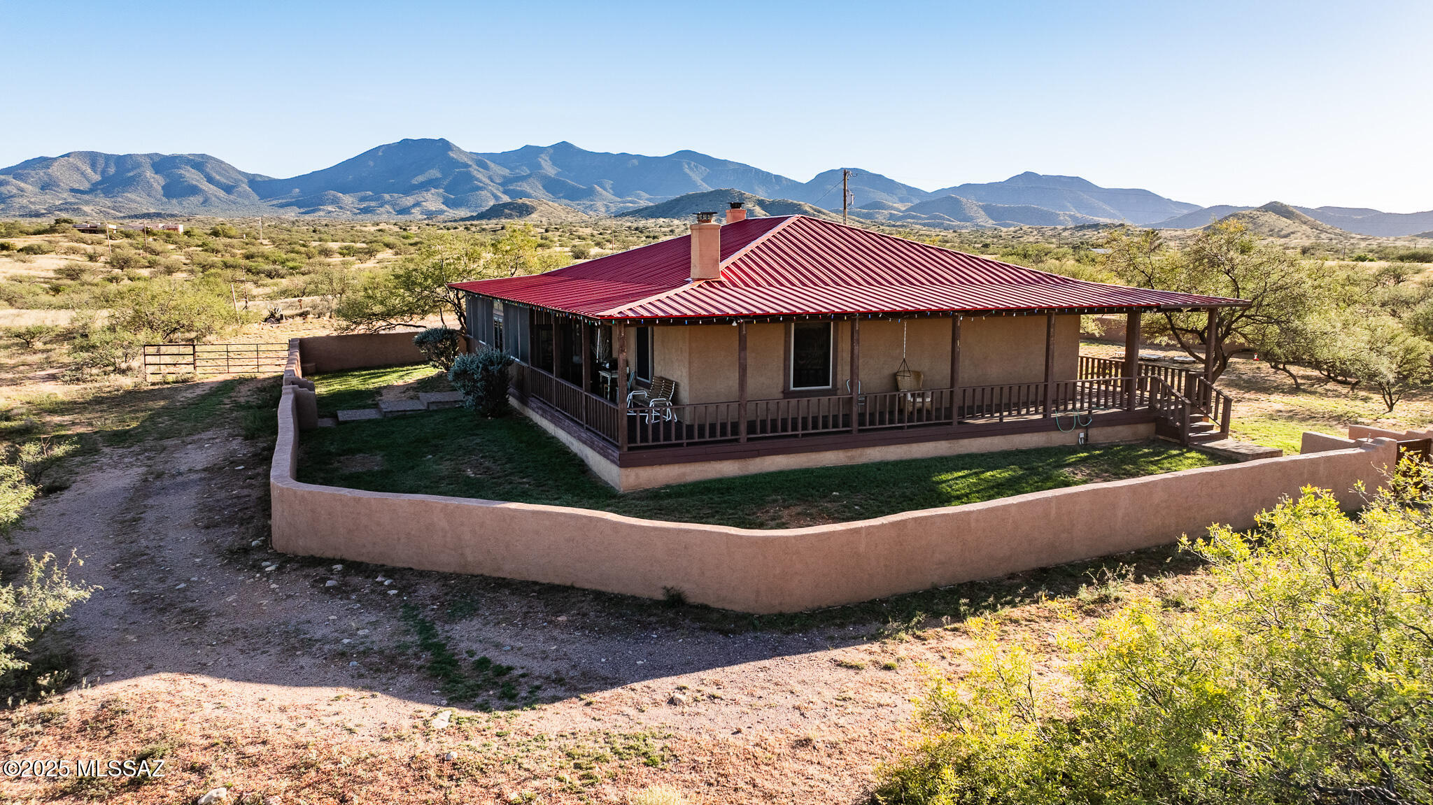 Rare opportunity to own a custom adobe home built by Fenn Homes, in the highly sought-after Whetstone Foothills community. This 2-bedroom, 2-bath home sits on 6 acres with panoramic mountain views. Featuring 1,907 sq. ft. of authentic Southwest charm, two fireplaces, and a wraparound porch--half screened, half open--perfect for relaxing and entertaining. The property includes a spacious 3-car garage and horse facilities, ideal for equestrian living. Enjoy peaceful desert surroundings with an easy commute to Tucson, Sierra Vista, and Benson. Located in the, Benson or Vail School Districts, this home offers the perfect blend of craftsmanship, comfort, and convenience. Homes like this don't come along often so call TODAY to see this beautiful property in person!