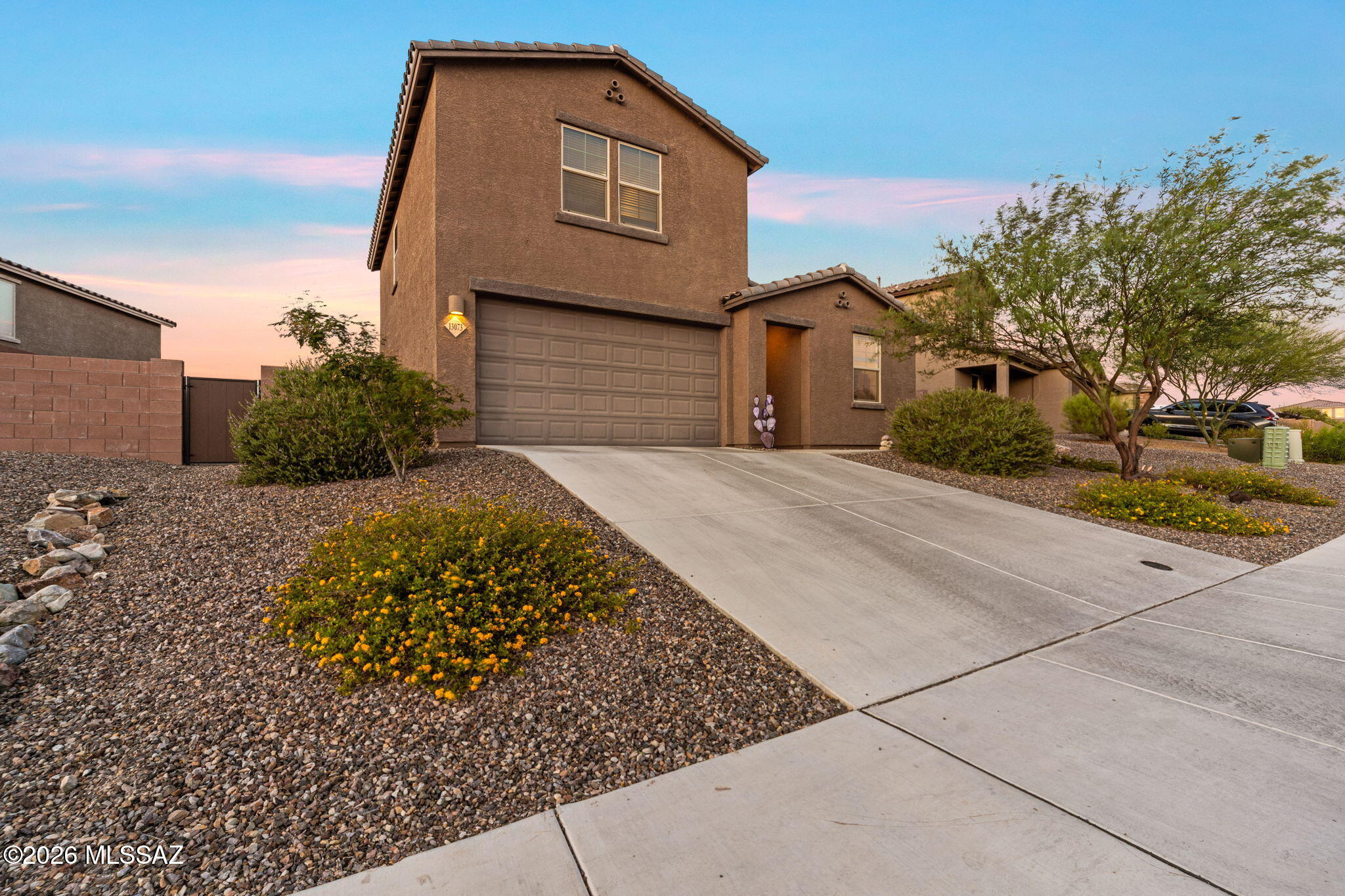 Located in the highly desirable Rocking K master-planned community and within the award-winning Vail School District, this newer 4-bedroom, 3-bath home is nestled in a private gated neighborhood and offers modern luxury, spacious living, and breathtaking mountain views. The open-concept floor plan features a large great room and chef's kitchen with granite countertops, double wall ovens, stainless steel appliances, abundant cabinetry, and a walk-in pantry. The main-level primary suite includes dual vanities, a walk-in shower, and generous closet space. Upstairs offers a versatile loft and additional living area. Complete with a 3-car tandem garage, epoxy floors, granite throughout, ample storage, and a spacious backyard, this home is the perfect blend of comfort and style.
