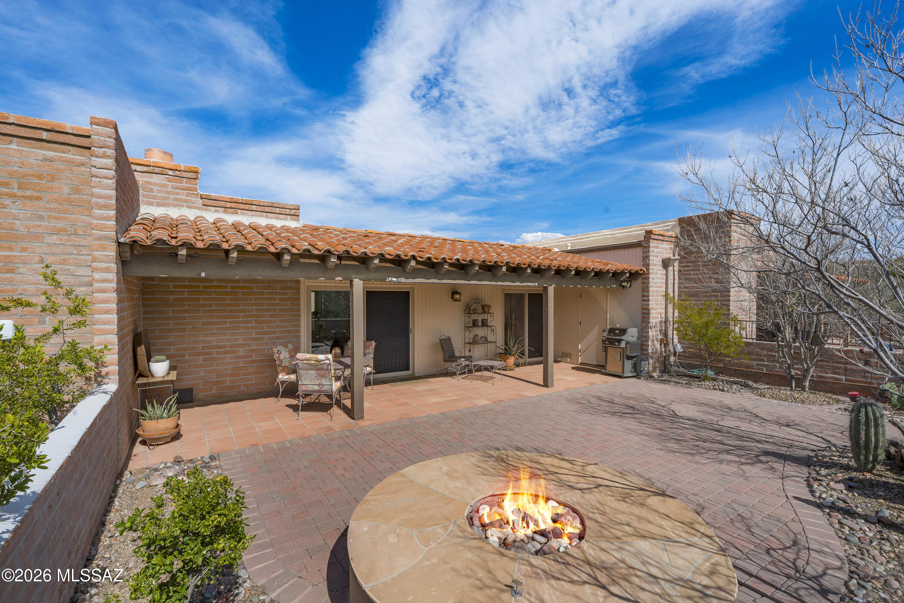 MUST SEE! Beautifully maintained 2BD/2BA burnt adobe townhome in Sunrise Territory Village, in the Fairfield Community of the Catalina Foothills. Spacious and well-designed 1,486 sq ft floor plan featuring classic Saltillo tile throughout, an updated kitchen and baths with shaker cabinetry, upgraded stainless steel appliances, and granite/quartz surfaces.

Additional features include custom plantation shutters, new double pained windows, solid wood interior doors, a clean double-car garage with epoxy flooring, and established desert landscaping. Outdoor enjoyment includes a private gas fire pit plus access to the community pool and spa.

Peace of mind comes with HVAC system,  roof and water heater regularly serviced and maintained. Old Republic Home Warranty included! This turn-key property offers rare access to a highly coveted Foothills community with limited turnover and is close to nearby amenities, shopping, dining, and outdoor activities including hiking, biking, and golf.
