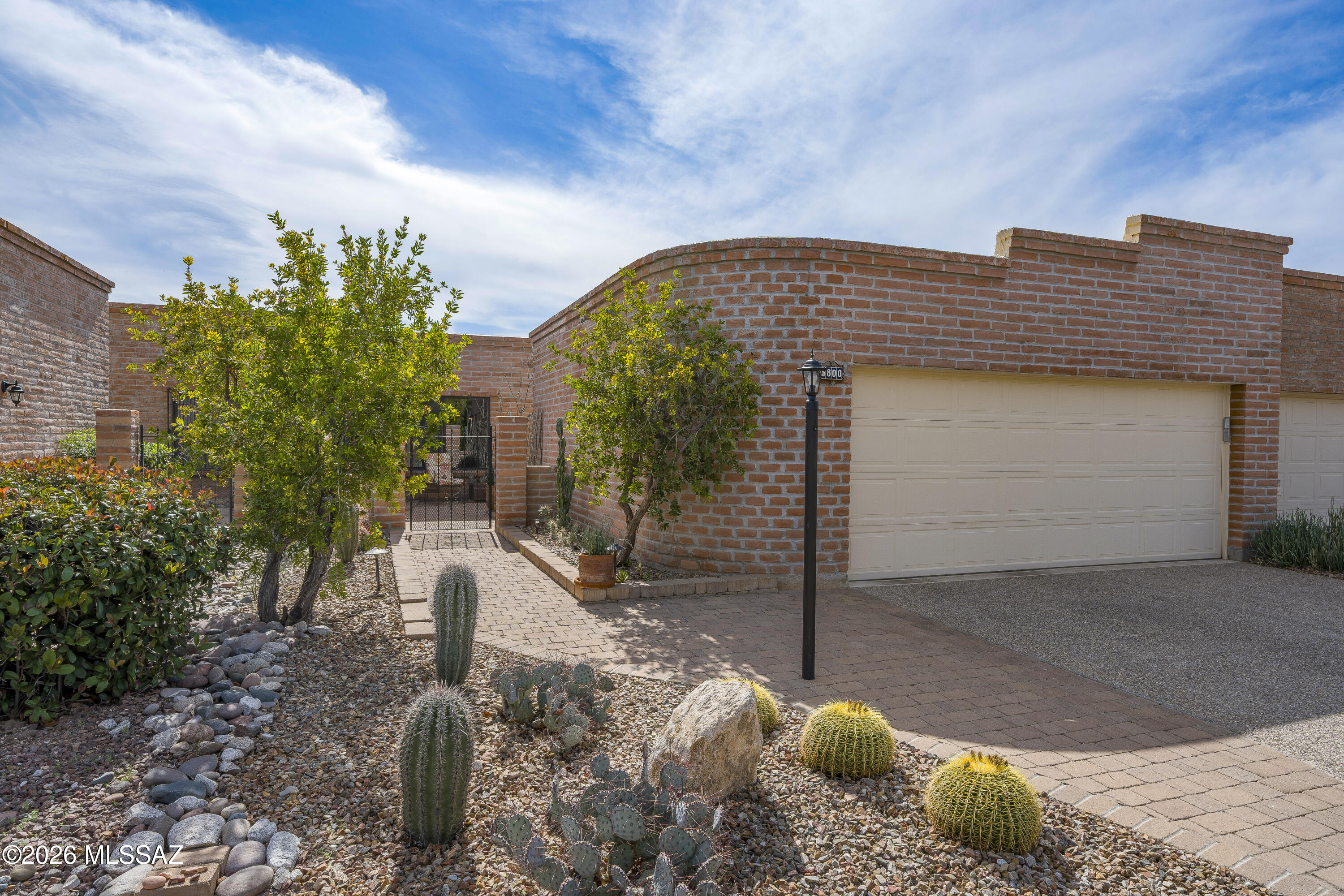 Turn-key burnt adobe townhome in Sunrise Territory Village, nestled within the sought-after Fairfield Community of the Catalina Foothills. This beautifully maintained 2BD/2BA home offers a spacious and well-designed 1,486 sq ft floor plan featuring classic Saltillo tile throughout, an updated kitchen and baths with shaker cabinetry, upgraded stainless steel appliances, and granite/quartz surfaces. Additional highlights include custom plantation shutters, new dual-pane windows, solid wood interior doors, a clean two-car garage with epoxy flooring, and established desert landscaping. Relax on the private patio with a gas fire pit or enjoy the community pool and spa. HVAC system, roof, and water heater have been regularly serviced and maintained for added peace of mind. This private, low-maintenance setting make it ideal for lock-and-leave living, whether you're downsizing, looking for a winter retreat, or simply ready to spend less time maintaining a home and more time enjoying the Foothills lifestyle. This sweet spot is just minutes from shopping, dining, hiking, biking, golf, and everyday conveniences.