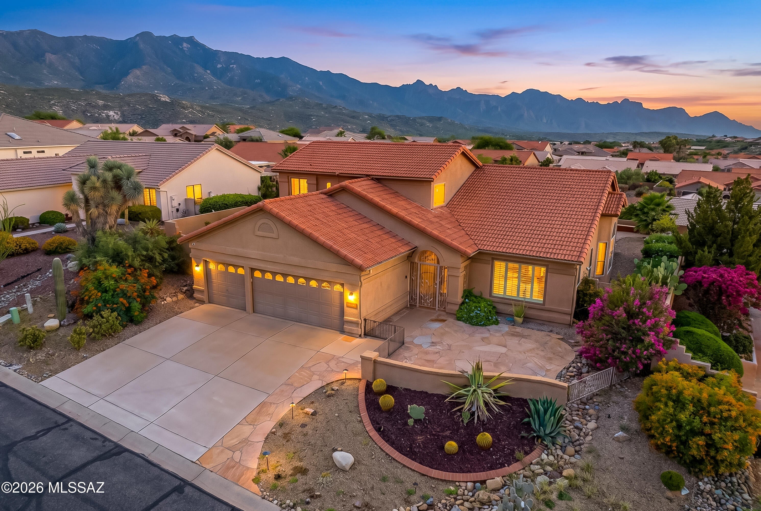 Welcome to this highly desirable Galleria model, thoughtfully updated and beautifully positioned on an elevated lot with breathtaking mountain views. A charming flagstone courtyard welcomes you and flows seamlessly into a screened patio, complete with security doors, creating a wonderful entry to the home. Elegant French glass panel doors open to a bright and inviting interior featuring soaring ceilings, plantation shutters, and an abundance of windows.  The fabulous gourmet kitchen is designed for both everyday living and entertaining, featuring granite countertops, crisp white cabinetry, stainless steel appliances, a gas range, double ovens, pendant lighting, and a spacious walk-in pantry. The adjoining family room offers a cozy gas fireplace and stunning mountain views, creatin the perfect space to relax and unwind.  The spacious primary suite is a true retreat with soaring ceilings, two walk in closets, executive height vanities with granite countertops, a beautiful walk-in shower, and direct access to the back patio. A versatile den, powder room, and well-appointed laundry room complete the first floor.  Upstairs are two generous guest bedrooms and a guest bath. The backyard is designed for enjoying the Arizona lifestyle, featuring a wood burning fireplace, extended patio, elevated seating area, low maintenance landscaping, and exceptional mountain views.  Well cared for and move in ready, this beautiful Galleria model offers the perfect blend of comfort, style, and spectacular views.