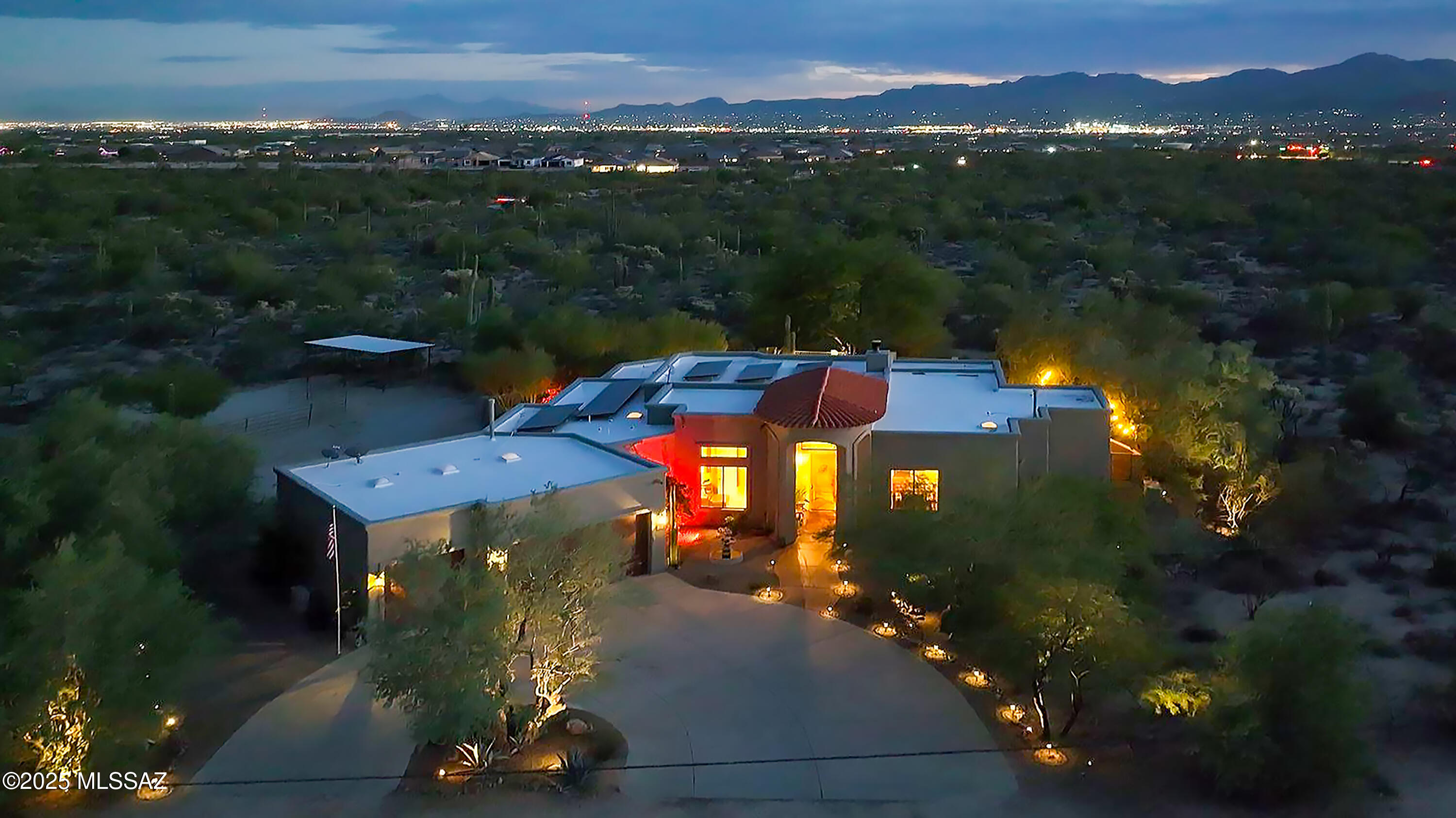 Very private and resort-like, this custom-built Northwest Tucson residence captures the essence of elegant desert living. Nestled on 2 acres surrounded by lush native flora and fruit trees, this exceptional property showcases breathtaking 360° views of the Catalina Pusch Ridge, Tortolita, & Tucson Mountains with sparkling city lights to the South and magnificent sunrises and sunsets painting the desert sky in every direction. In the early morning light, hot air balloons drift gracefully across the western horizon above the Tucson Mountains, adding yet another touch of desert magic! The terraced wraparound patio, complete with remote-controlled electric eyebrow shades, provides an idyllic setting for a morning coffee or evening gatherings. Check out the Video & Virtual matterport tour Inside, the spacious 4-bedroom, 3-bath split-bedroom design features soaring 12-foot ceilings, walls of windows framing stunning mountain views, and a grand sense of space and light throughout. The gourmet kitchen is a showpiece perfect for entertaining with an induction cooktop, Bertazzoni telescopic hood, granite countertops, and a generous breakfast bar. Elegant granite executive-height vanities and custom Knotty Alder cabinetry flow throughout, highlighted by a striking 8-foot solid entry door. The open great room centers around a warm wood-burning fireplace and newer French doors provide access to outdoor living spaces.
A private guest suite with its own wing and entrance offers exceptional flexibility for multi-generational living or extended guests. Zoned for horses and complete with horse facilities. This Electric Energy Efficient home has an owned Solar System with net metering. 
Ideally located near The Loop multi-use path, Catalina State Park, The Gallery Golf Club, The Highlands Golf Club, and Tortolita Mountain Park, & Preserve, this property offers an unparalleled blend of serenity, privacy, and proximity to some of Tucson's most stunning recreational destinations. Only minutes from I-10, Shopping and Restaurants.
(Be sure to view the video, and the Matterport virtual tour at the tabs above, they are truly amazing!)