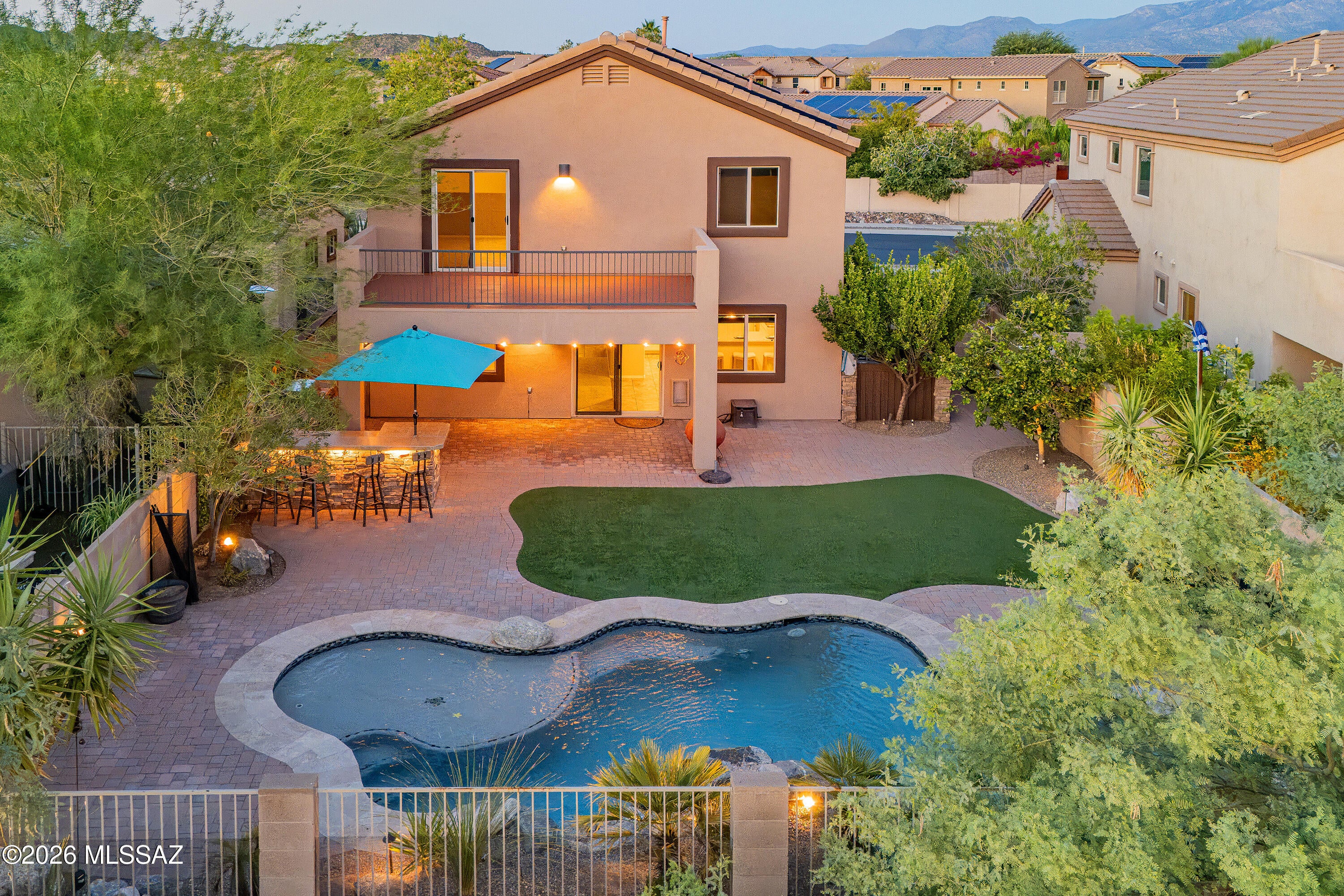 First time on the market! Enjoy natural open-space views, walkability to a nearby park, a resort-style backyard with a saltwater pool and outdoor kitchen, plus fully owned solar in this meticulously upgraded, one-owner D.R. Horton-built home. Purchased new, this Oro Valley property offers exceptional indoor/outdoor living.
This move-in-ready 3-bedroom + den, 3-bath home features multiple living areas, a 2-car garage, and was refreshed in August 2026 with new carpet and fresh interior paint throughout. The kitchen features a brand-new, never-used refrigerator, breakfast bar, and large pantry. Smart-home features include switches throughout, a smart thermostat, smart door lock, and smart garage door opener. The spacious primary suite offers mountain views and a dual rain-shower system. Custom touches throughout include wainscoting, built-in loft beds, and a fun secret kids' room created within the coat closet.
The backyard is designed for both entertaining and relaxation, featuring a saltwater pool with waterfall, outdoor kitchen with natural gas, artificial turf, lush landscaping, landscape lighting, pavers, a hydroponic garden, and a custom trellis. The balcony/deck overlooks the backyard, natural open space, and beautiful sunset views.
Additional highlights include a newer water heater (2026) and fresh exterior paint (2025), along with numerous additional upgrades - see the full list in the documents.
A rare opportunity to own an exceptional Oro Valley home in a desirable neighborhood, close to shopping, eateries, parks, golf, and hiking - with open-space views, resort-style outdoor living, and fully owned solar, all lovingly maintained by its original owner.
[Agent related to Sellers]