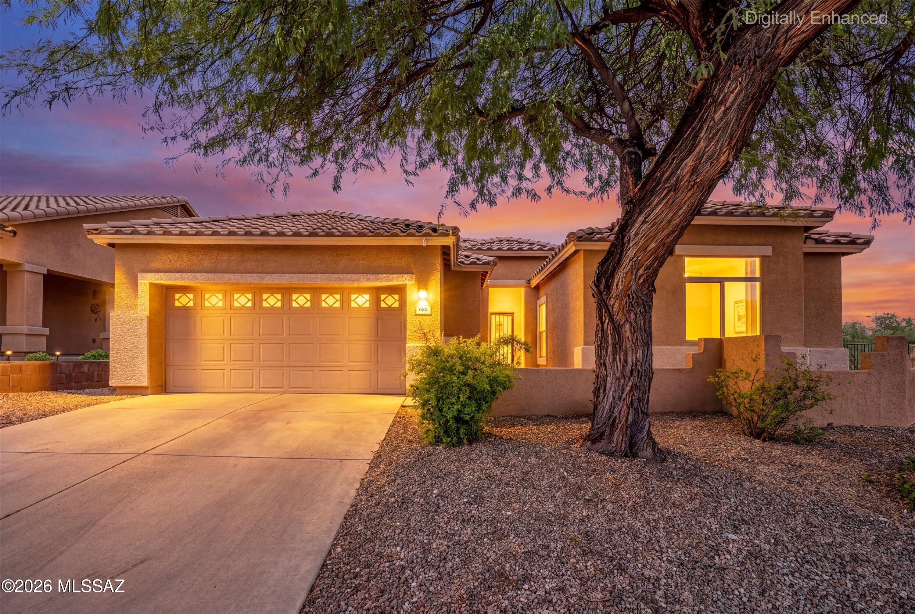 Beautifully maintained and thoughtfully designed, this single-story home in Oro Valley's desirable Tangerine Terrace offers 1,964 square feet with 3 bedrooms, 2 bathrooms, a spacious great room, split-bedroom layout, and corner homesite.
Step inside to soaring ceilings, abundant natural light, and 18-inch tile extending throughout the entire home--no carpet. The open great room feels spacious yet inviting, with a gas fireplace creating a warm focal point and an easy flow between the living, dining, and kitchen areas.
At the heart of the home, the kitchen features granite countertops, a generous center island, walk-in pantry, gas cooktop, black appliances, abundant cabinetry, and plenty of space for everyday living and entertaining while staying connected to the main living areas. The split-bedroom design provides separation between the primary suite and secondary bedrooms. The primary suite includes a large walk-in closet and en-suite bath with dual vanities, a tub/shower combo, and generous counter space. Two additional bedrooms and a full guest bath provide flexible space for a variety of uses.
Out back, the covered patio extends the living space outdoors to a thoughtfully landscaped backyard featuring artificial turf, pavers, mature desert landscaping, and a raised garden area ready for flowers or seasonal plantings. Enjoy views of the Santa Catalina Mountains and the surrounding Southern Arizona landscape.
Conveniently located near shopping, dining, recreation, and other Oro Valley amenities, 622 W Tremolo Lane offers comfortable single-level living in a desirable Oro Valley location.
Beautifully maintained. Thoughtfully designed. Welcome home.