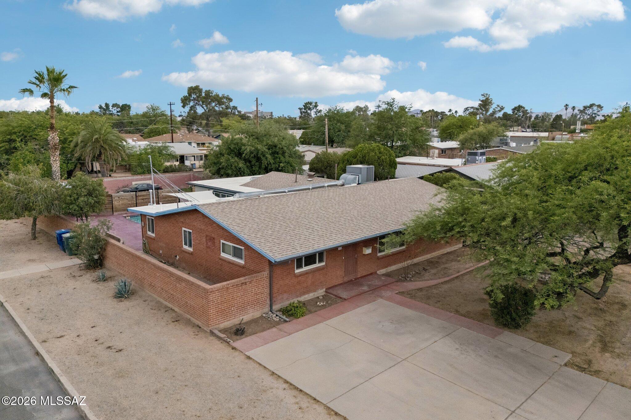 Spacious and open 4 bed, 2 bath w/ den Centrally located home on a corner lot. Unique open floor plan with a recently remodeled kitchen with an island, quartz countertops and SS gas appliances overlooking the pool area. Sizeable bedrooms; ceramic tile flooring throughout. Large pool with fenced area and gazebo; backyard with turf and pavers. Property has space for RV or additional parking with gate access. Convenient location; less than 2 miles away from Banner UMC; short distance to shopping, dining and parks.