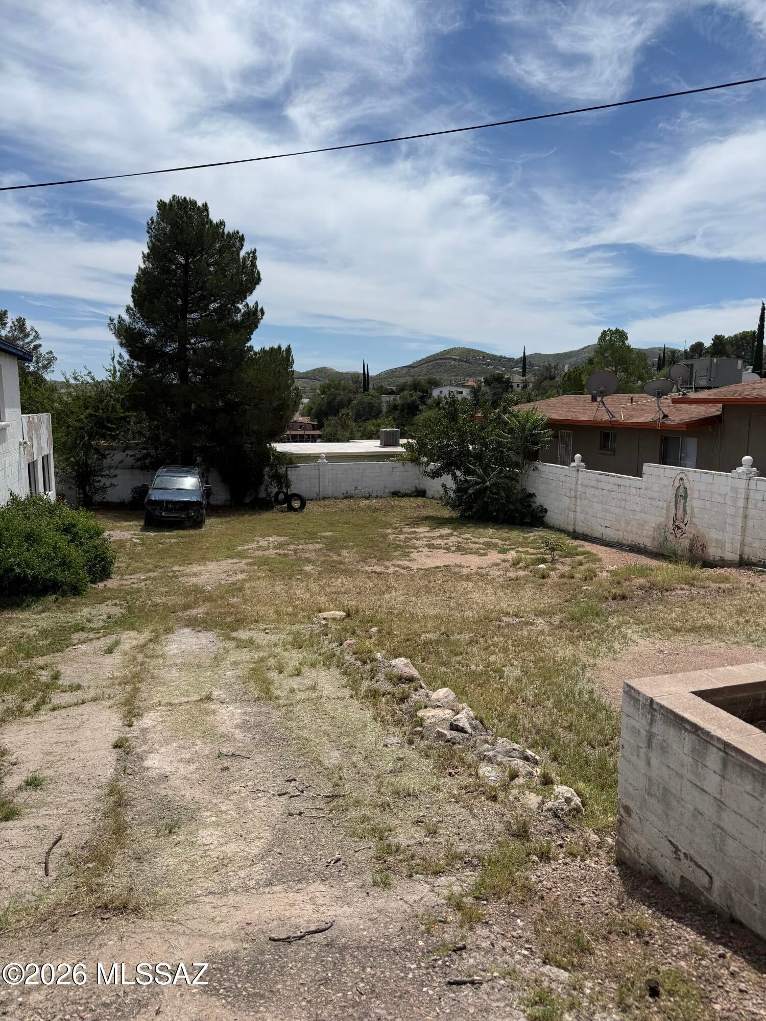 Two story home with two city lots! 3 bedrooms on main floor with fireplace and one bedroom downstairs with living room and fireplace, 4.5 baths, laundry room, extended nice covered patios, two A/C units! Second lot a plus! 2 outside storage areas connected to the house.