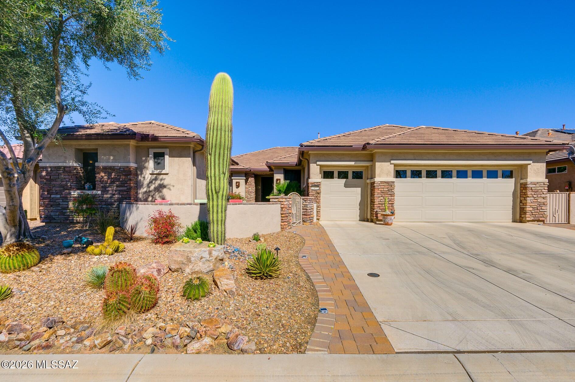 Indulge in a luxurious lifestyle in Southern Arizona's desirable Robson community, where leisure and activity harmonize within a stunning residence that fulfills all your needs. This stunning single-owner home exudes elegance, featuring exceptional upgrades that set it apart. As you enter, you're welcomed by an inviting atmosphere, highlighted by neutral, diagonally laid floor tiles that provide a versatile backdrop for your personal decor. The great room is a masterpiece of design, boasting a beautiful stone wall that elegantly frames the television and a cozy electric fireplace, perfect for adding warmth and ambience to your gatherings. The heart of the home, a chef's dream kitchen, awaits with mid-tone cabinetry, a generous center island, a wall oven, and an electric cooktop, all complemented by striking countertops and decorative tile backsplash. A den with a built-in desk offers a tranquil workspace with sliding patio doors leading to the charming front courtyard and a separate guest casita, ensuring privacy and comfort for your visitors.  Awake to picturesque views of the meticulously landscaped backyard and the rolling greens of the Roadrunner Golf Course from the primary suite, adorned with large windows dressed in plantation shutters. The indulgence continues with a generous offering of furniture, furnishings, and even a golf cart available by separate bill of sale, ready to complement your new lifestyle. At Quail Creek, enjoy an array of resort-style amenities where a world of social clubs, activities, and premium facilities are at your fingertips. From championship golf courses, 32 pickleball courts, numerous pools, to a state-of-the-art fitness center and spa lounge, this is more than a home; it's a community where life flourishes.