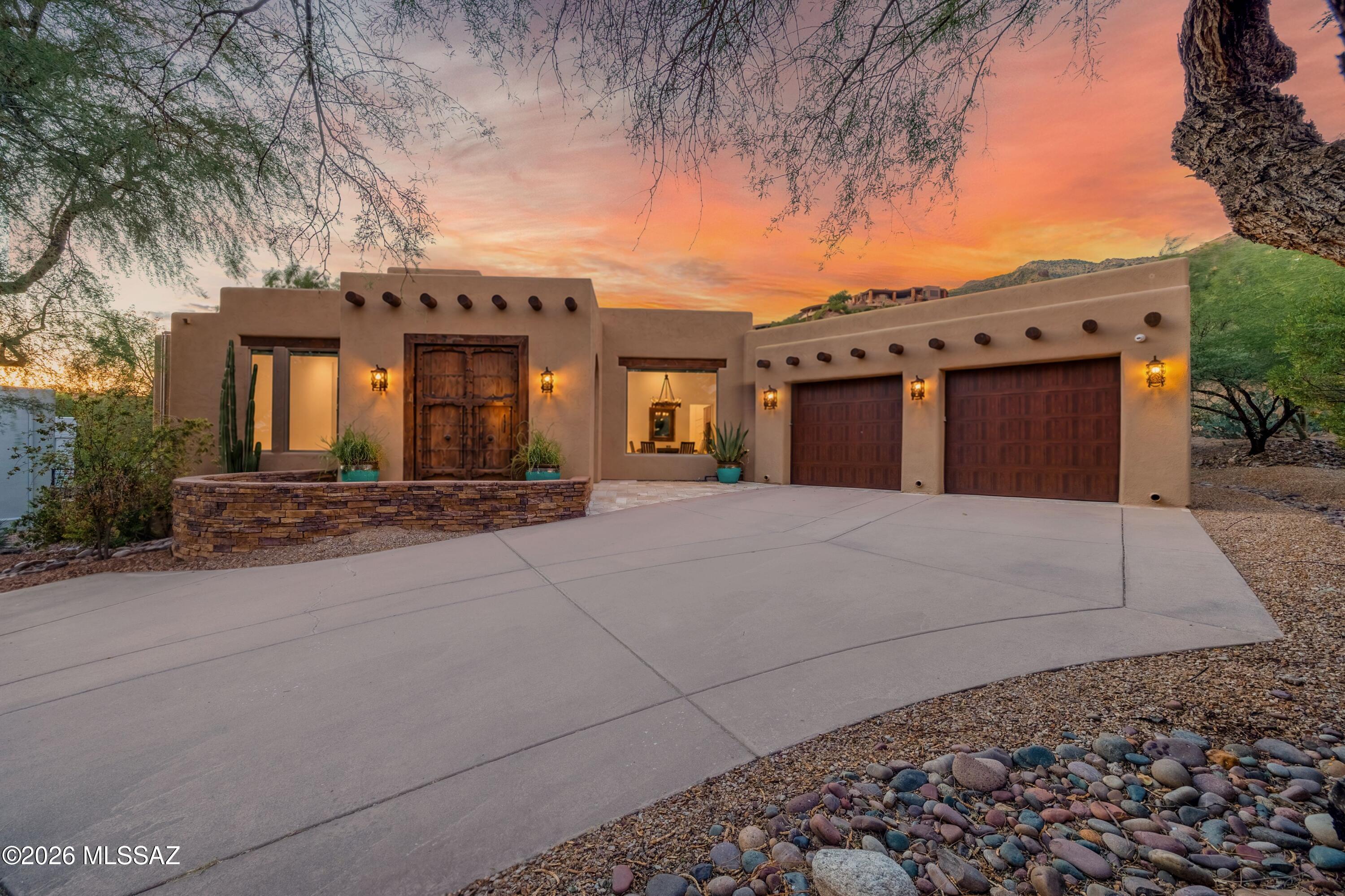 Rare 2,671 SqFt custom home tucked into a cul-de-sac in the guard-gated Ventana Canyon community. This single-level residence offers 2BR, 3BA and 2 offices - both can easily be converted to additional bedrooms. The open, split-bedroom floor plan features high ceilings and oversized windows that fill the home with natural light. Improvements completed from 2023-2025 include owned solar with battery backup, kitchen appliances, 2 HVAC's, 2 water heaters,  2 garage doors, vinyl floors, motorized blinds and a landscape drip system. Enjoy private outdoor living with a covered patio, outdoor kitchen, fire pit, mountain views and sparkling spool. Additional highlights include an oversized 2-car garage and antique decorative entry doors. Close to Ventana Canyon Country Club & District 16 schools.