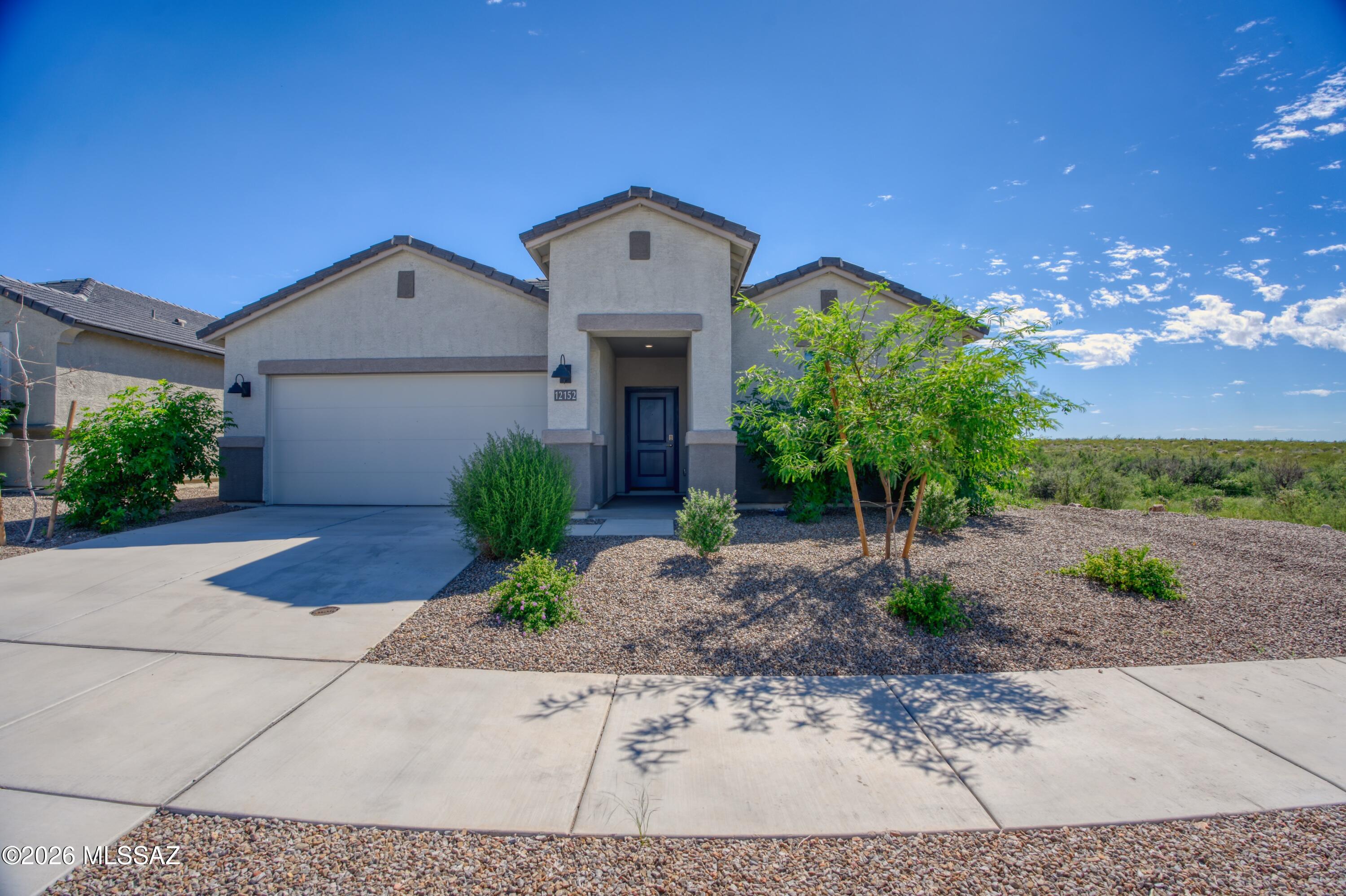 Welcome to the Kingston at Hanson Ridge in Vail, Arizona! This 2,053 sq. ft. single story home sits on a desirable corner lot with a private park directly in front and no neighbor on the right side, offering added privacy and an open feel. Inside, the bright, spacious layout connects the living room, dining area, and kitchen for comfortable everyday living and easy entertaining. The kitchen features Quartz countertops, modern appliances, and a convenient pantry. The private primary suite is located at the back of the home and includes a spacious bedroom, large walk-in closet, and a suite bathroom with dual vanities and a walk in shower. A beautiful home in a great setting!