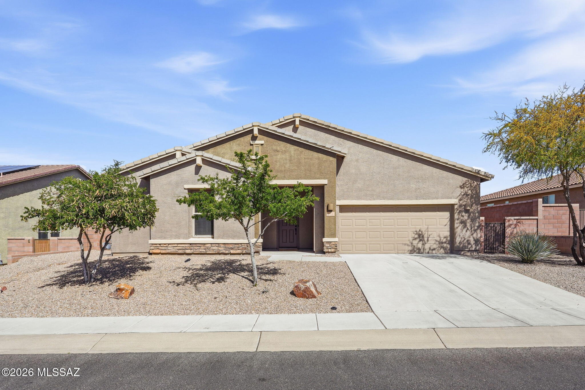 Experience refined desert living where privacy, space, and mountain views come together in a beautifully designed single-story home. Offering 2,924 sq. ft., this spacious residence features four bedrooms, three bathrooms, and a tandem three-car garage, providing both flexibility and functionality for modern living.
The thoughtfully designed floor plan, one of the most sought-after in the community, centers around an open great room filled with natural light from expansive windows. Attractive tile flooring flows throughout the main living areas, complemented by elegant new paint throughout that adds warmth and style.
A versatile front living space provides endless possibilities and can easily function as a formal dining room, second living area, home office, or playroom. The well-appointed kitchen is designed for both everyday living and entertainment, featuring stainless steel appliances, double ovens, abundant cabinetry, and a grand island that anchors the space while overlooking the great room.

The spacious primary suite serves as a private retreat with dual vanities, a soaking tub, separate shower, and a generous walk-in closet. Three additional bedrooms and two bathrooms provide ample space for guests, family, or flexible use.

Step outside to a backyard designed for relaxation, where tranquil views of the Catalina Mountains create a beautiful natural backdrop. Located within the secure gates of Encore at Madera Highlands, residents enjoy a peaceful setting while remaining conveniently close to shopping, dining, and outdoor recreation.
This exceptional home combines privacy, views, and a highly desirable layout in one of the area's premier gated communities.
