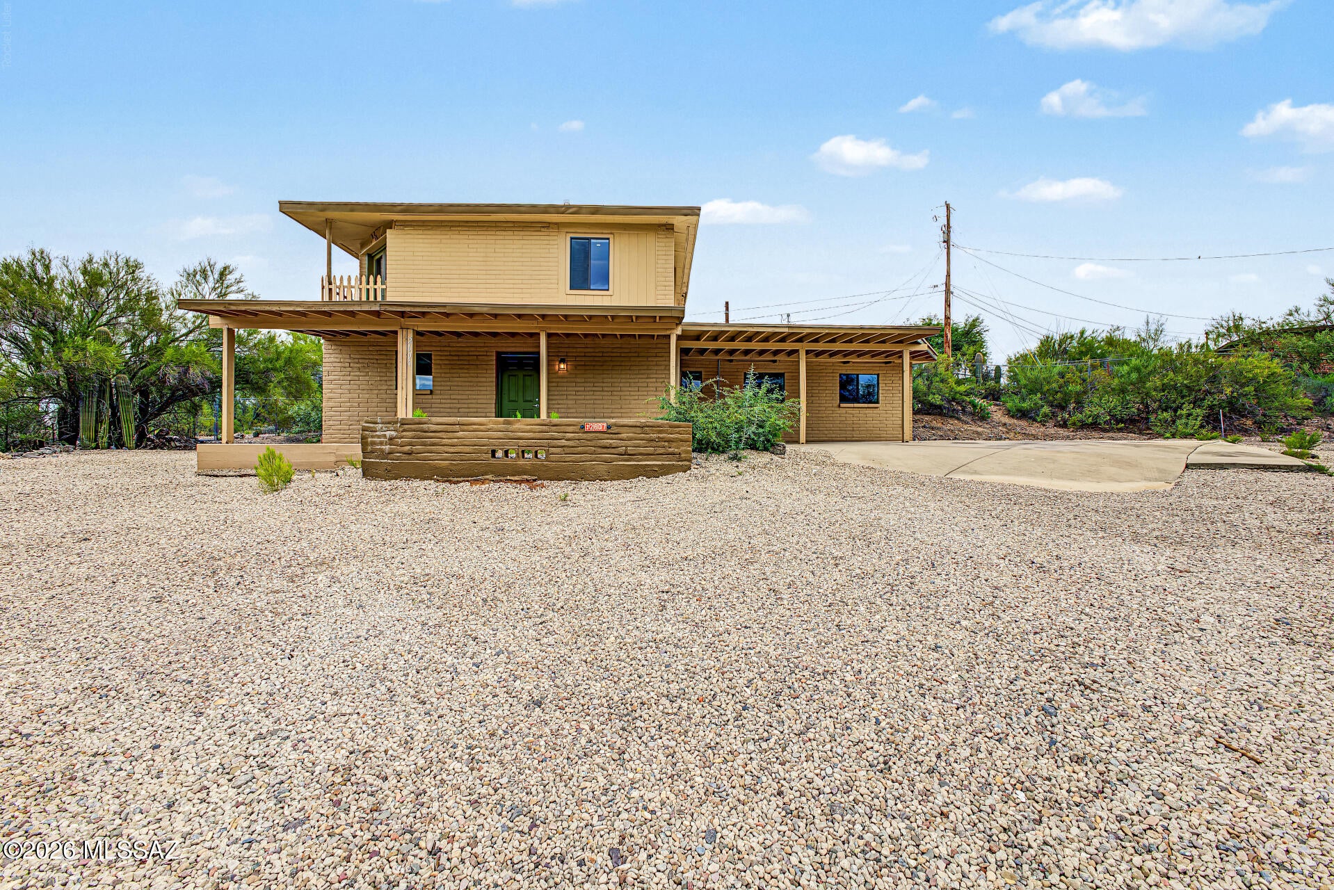 Fall in love with this charming 2-story home in Tucson! NO HOA! Featuring 2 beds, 2 baths, a low-care landscape, and an inviting front porch. Inside, you'll find high ceilings, abundant natural light, a neutral palette, wood-look floors & soft carpet in the right places, and connected living and dining areas. The kitchen boasts white shaker cabinetry, granite counters, SS appliances, a gas range, and a center island. Upstairs, a spacious loft bedroom provides access to a covered balcony overlooking the mountains. The bedrooms offer closet storage, while both bathrooms include a tub/shower combo. A dedicated laundry room adds convenience. Outside, the spacious lot offers a lot of potential for your own backyard retreat. Don't miss this gem! Seller willing to carry.