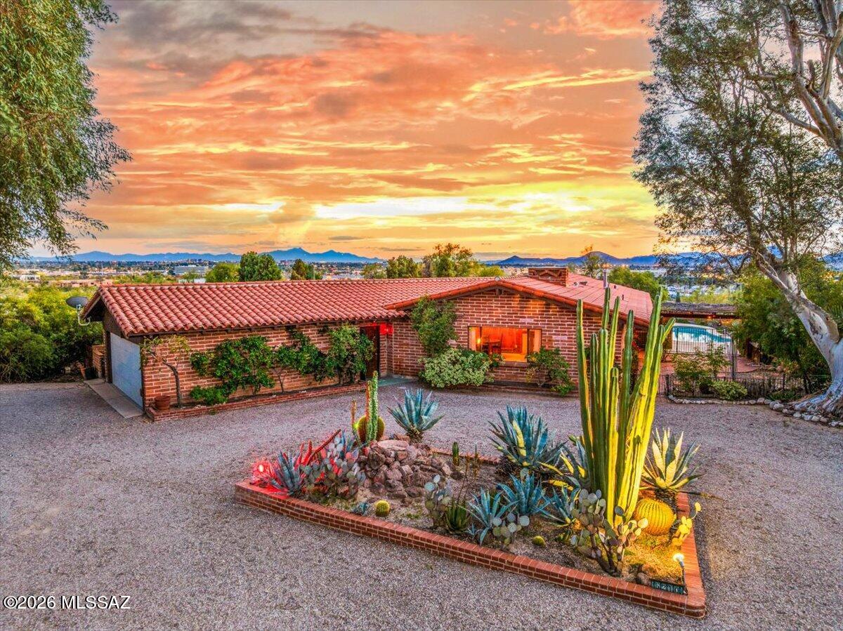 Welcome home to a truly one-of-a-kind Tucson sanctuary. Located on a premier view lot in the sought-after Oracle Foothills neighborhood, this spectacular mid-century modern home offers breathtaking panoramic city & mountain views, exceptional privacy & a deep connection to the surrounding desert landscape. From the moment you arrive, the curb appeal & evident pride of ownership set the tone for something special. Inside, soaring tongue-&-groove ceilings & an abundance of natural light create a warm, authentic welcome. The home beautifully honors its mid-century roots while blending comfort & functionality. The era-appropriate kitchen features charming details & cool, calming tones, perfectly positioned to overlook the backyard oasis & endless views beyond. The expansive primary suite is a peaceful retreat, complete with a spa-like bathroom and walk-in closet. Outdoors, the property truly shinesfragrant gardens, a flagstone patio, inviting Arizona room, and a sparkling pool all come together to create an unparalleled setting for relaxation or entertaining, with sweeping vistas as your backdrop. Even the towering trees seem to whisper tranquility in this serene environment.
Lovingly updated, the home includes a newer artisan tile roof, new water and gas lines, a newer hot water heater, and more, offering peace of mind while preserving its timeless character.
Just minutes from Tucson's finest dining, shopping, and amenities, this home feels worlds away while remaining perfectly central. The Oracle Foothills neighborhood is known for its friendly, walkable streets and vibrant sense of community, with regular events and opportunities to connect.